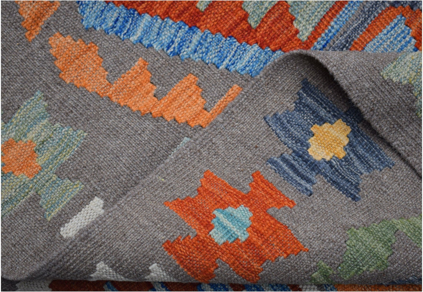 Handwoven Afghan Maimana kilim featuring a grey background with colorful geometric patterns.