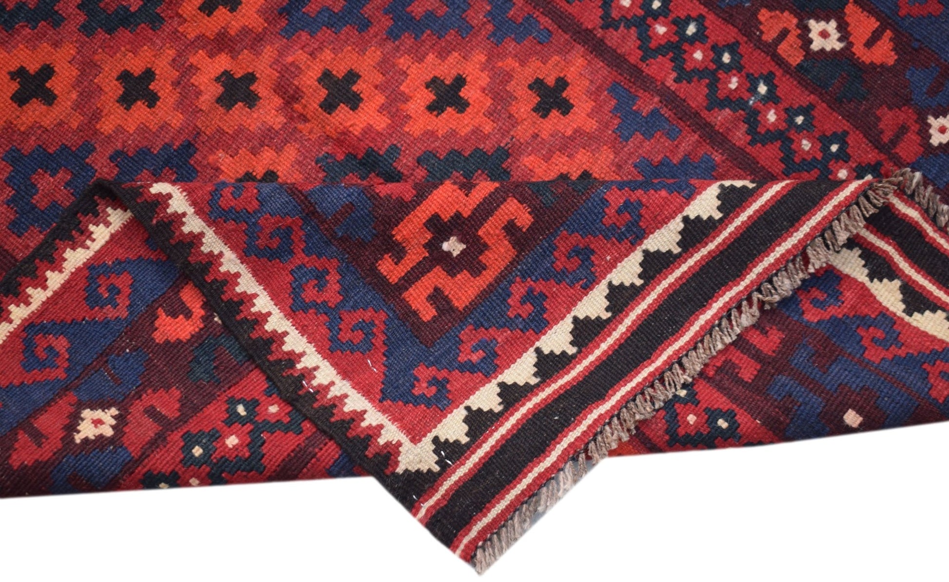 Handwoven Afghan Maimana kilim runner featuring geometric patterns in red, blue, and cream wool.