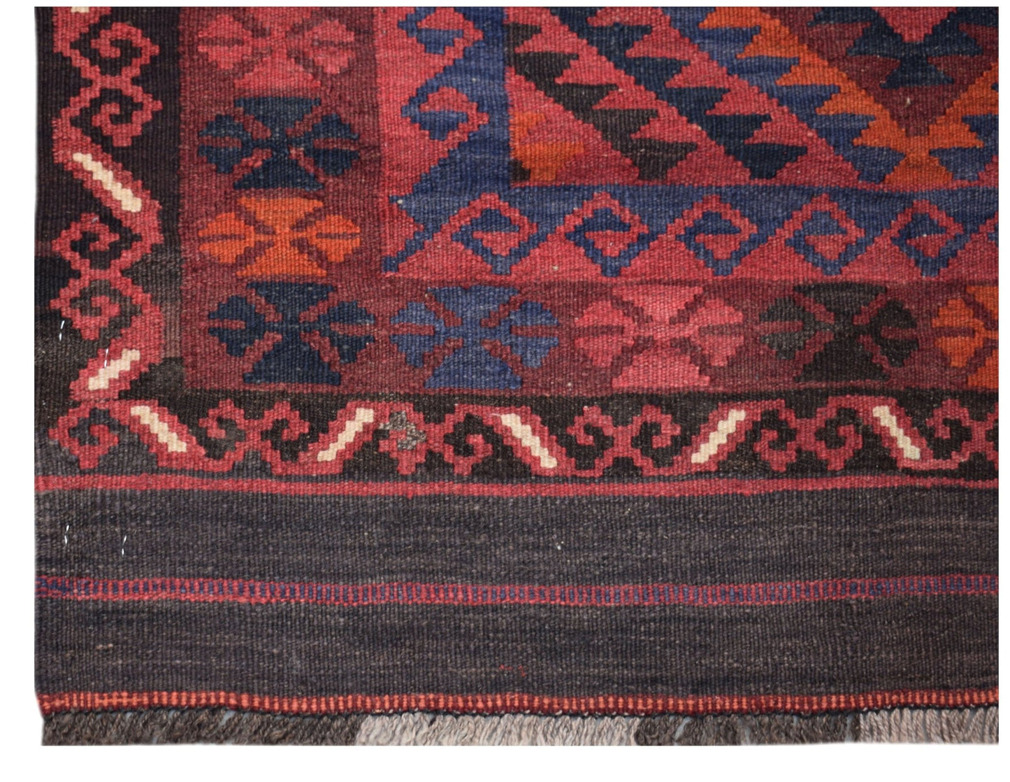 Handwoven Afghan Maimana kilim runner featuring geometric patterns in red, blue, and orange wool.