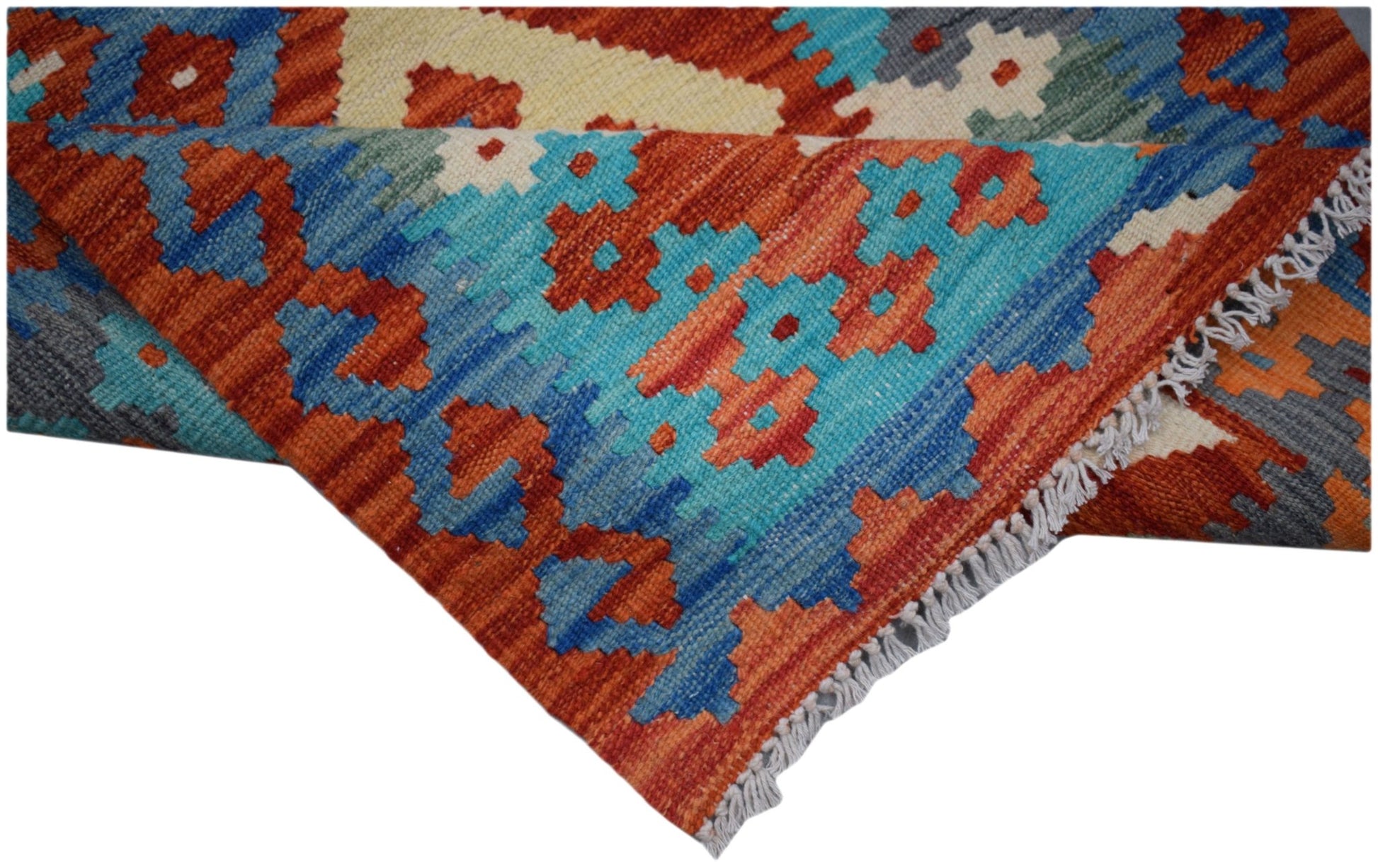 A handmade Afghan Maimana wool runner featuring a vibrant geometric pattern in blue and orange.