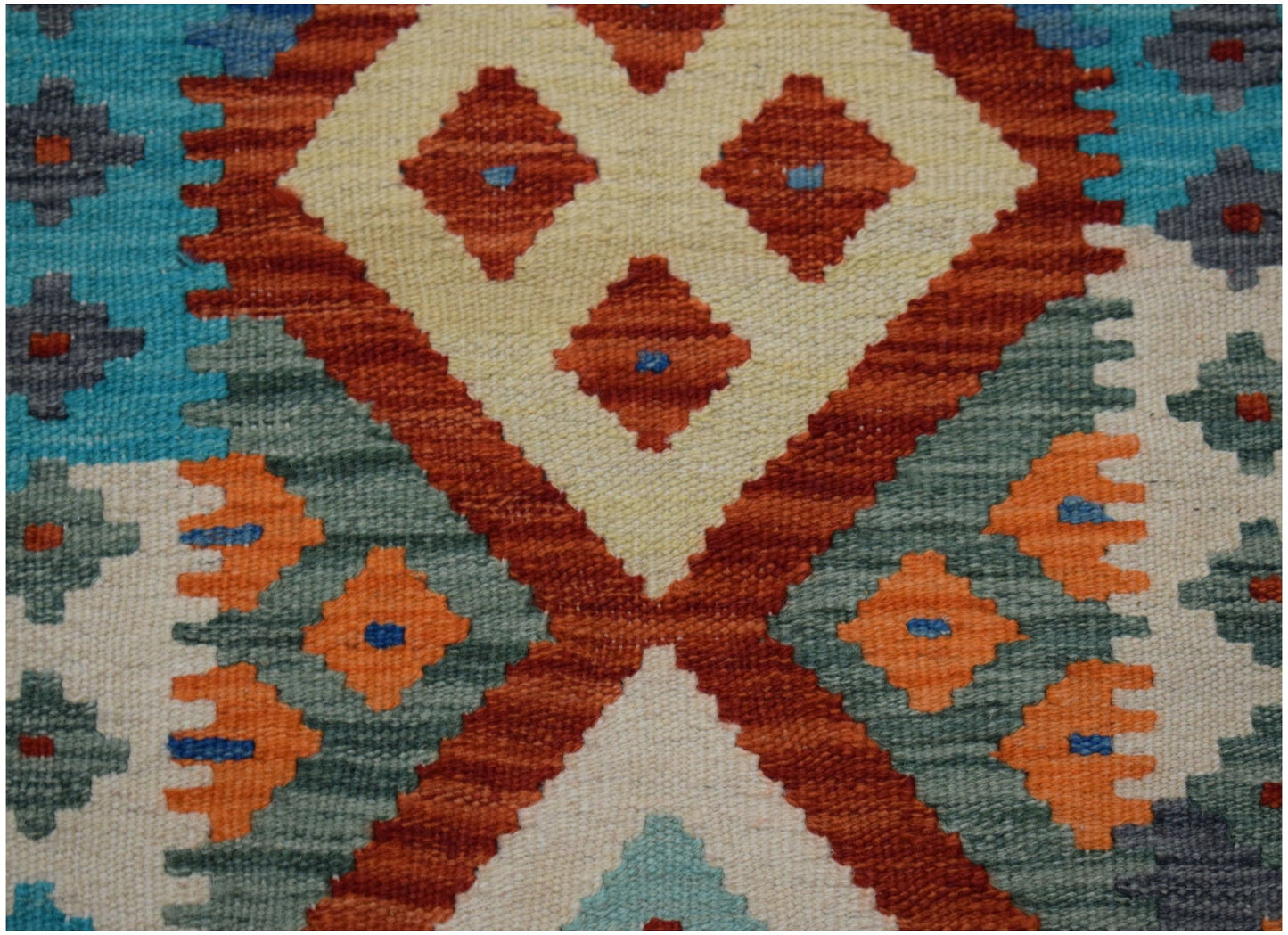 Handwoven Afghan Maimana kilim runner featuring a geometric pattern in orange, blue, and cream.