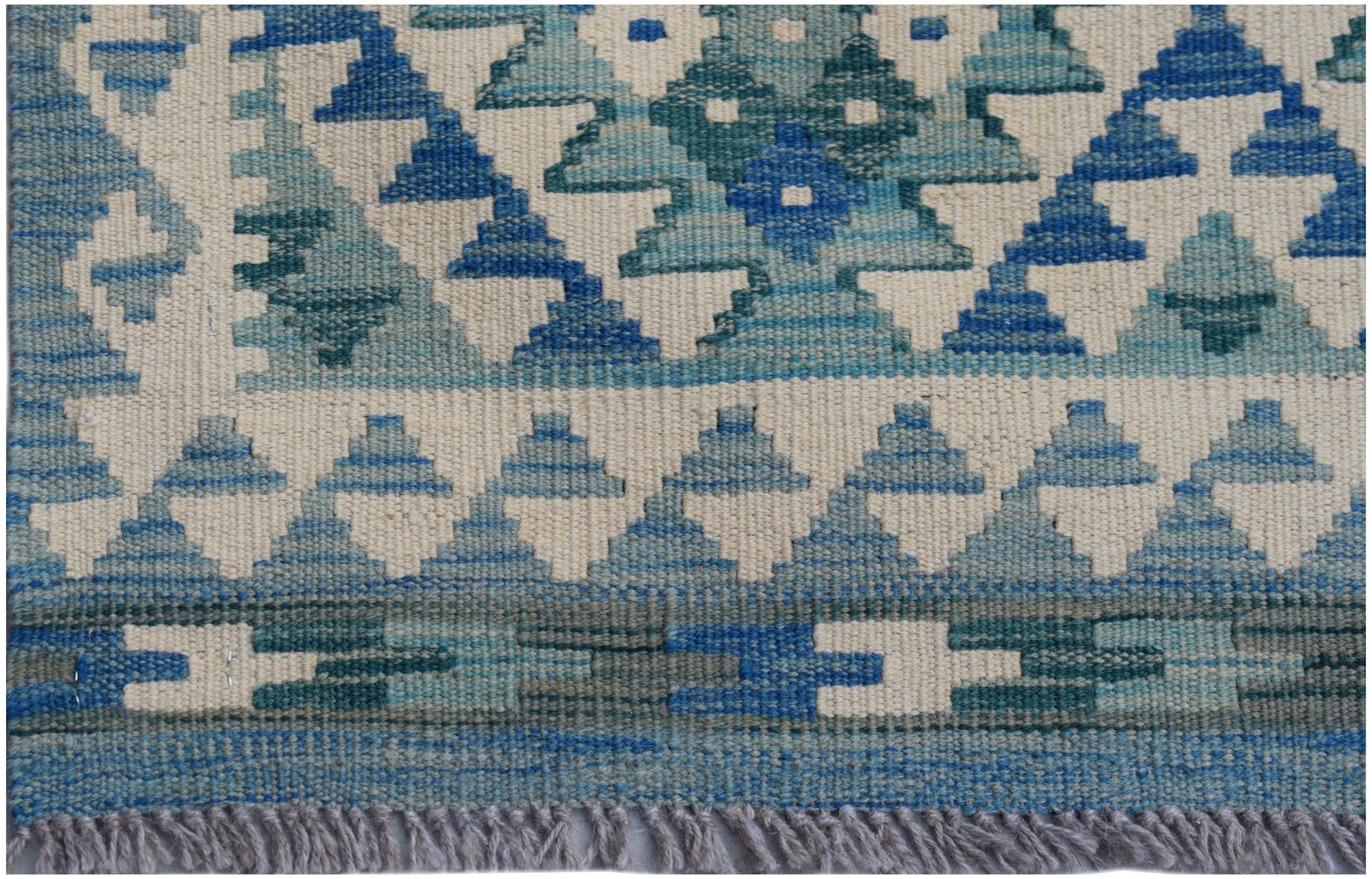 Handwoven Afghan Maimana wool runner featuring a geometric pattern in shades of blue and cream.