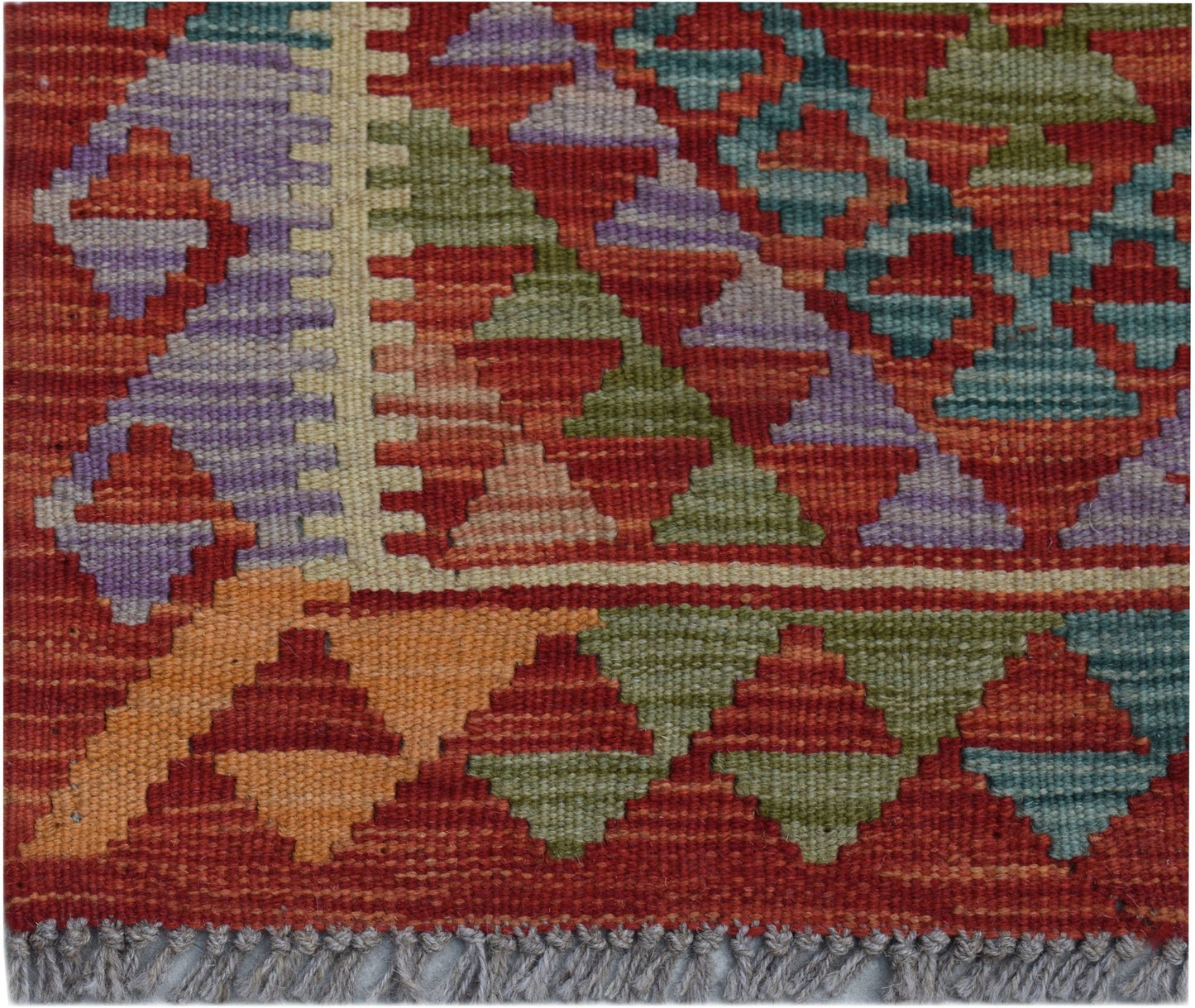 Handwoven Afghan Maimana wool kilim runner featuring a geometric pattern in vibrant colors.
