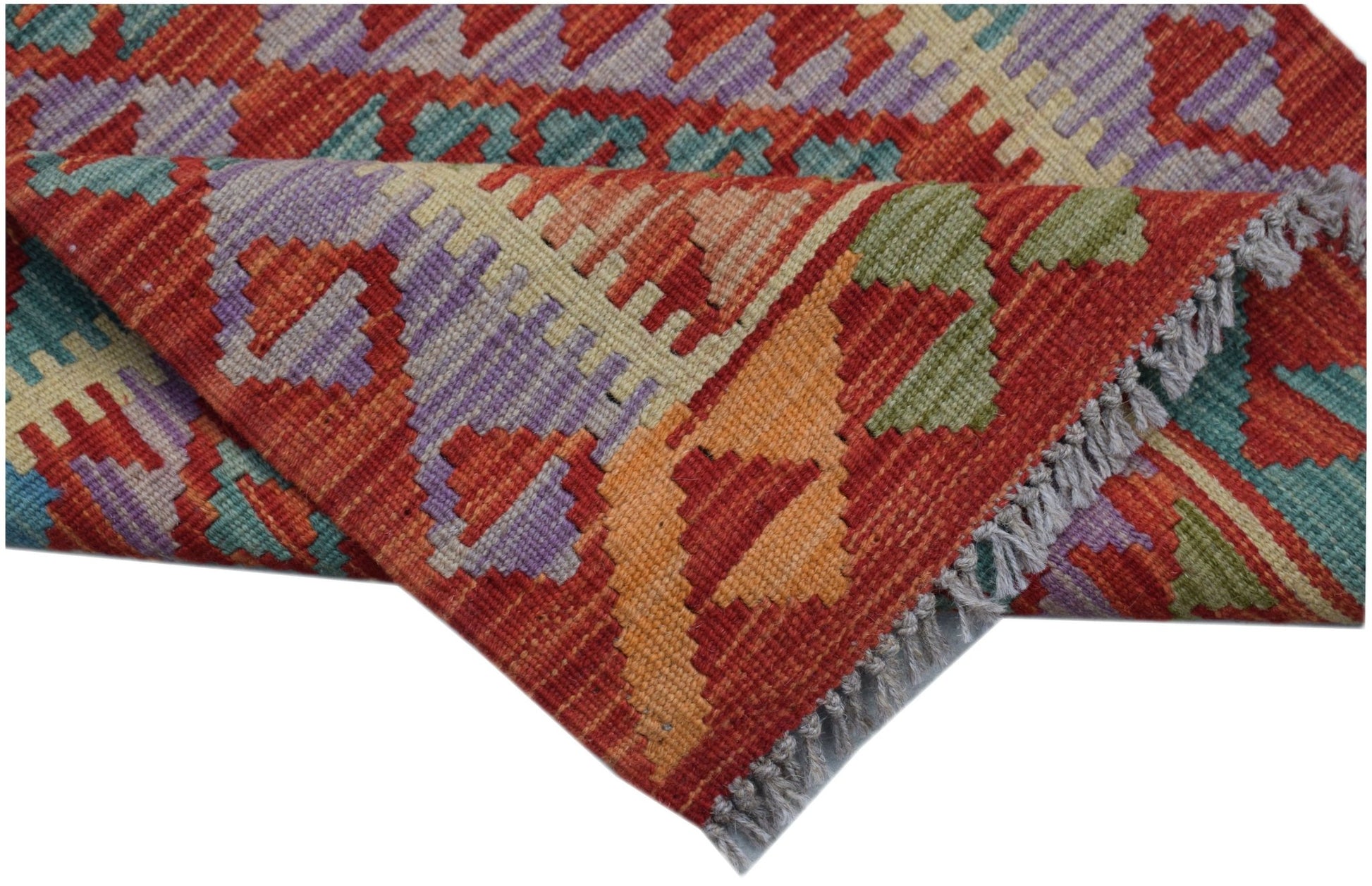 Handwoven Afghan Maimana wool kilim runner featuring a geometric pattern in vibrant colors.