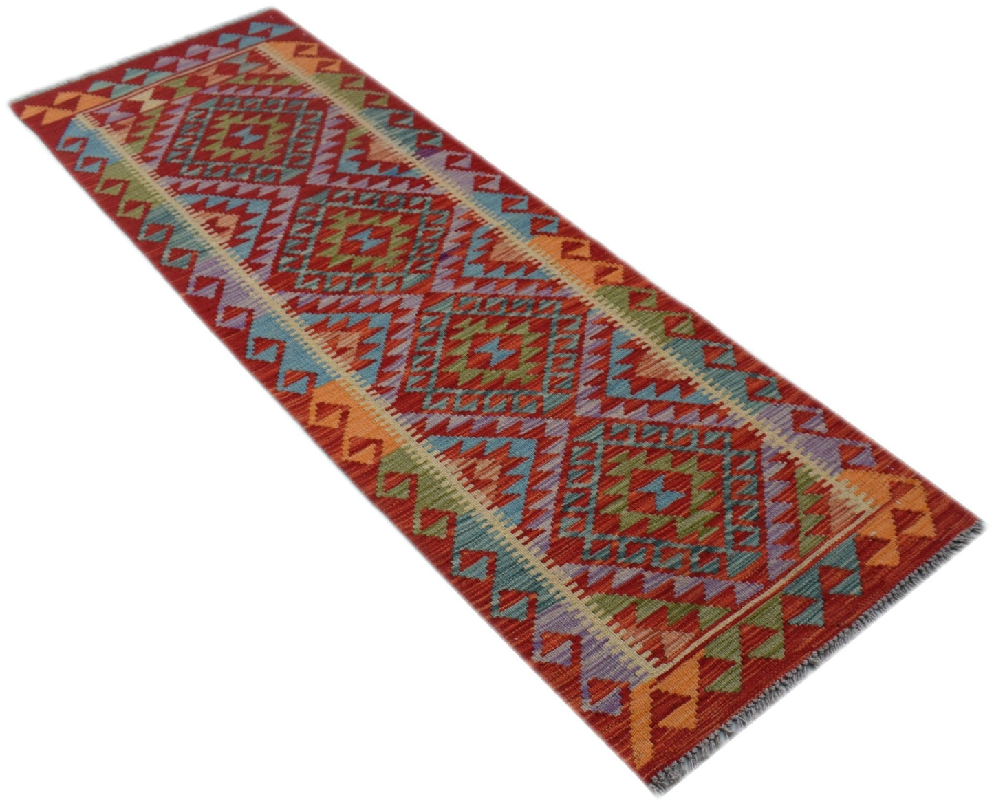 A handmade Afghan Maimana wool runner rug featuring a vibrant geometric pattern in warm tones.