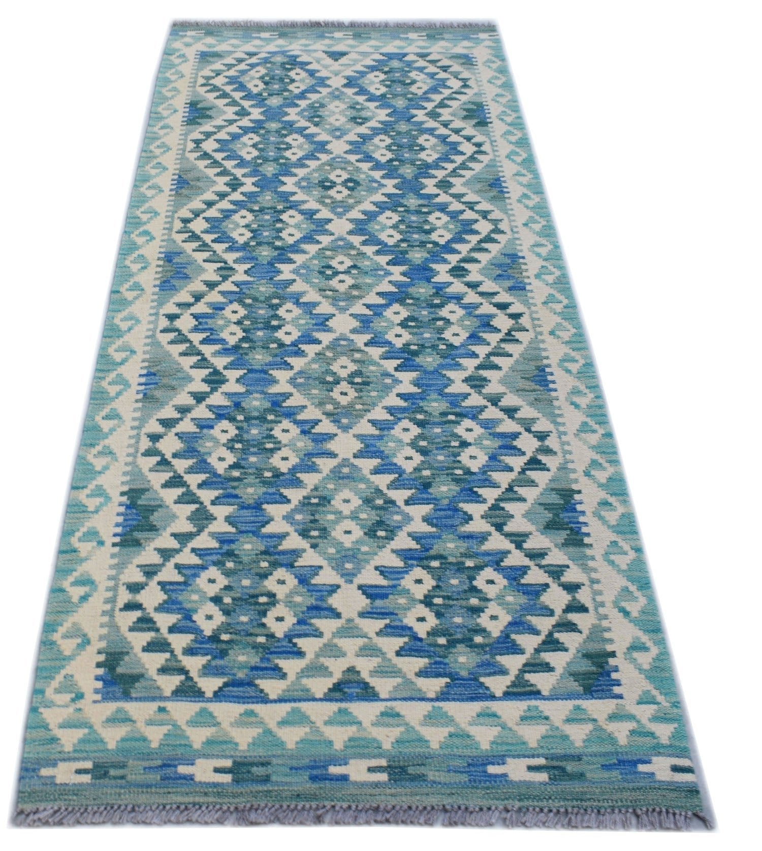 A handmade Afghan Maimana wool runner rug featuring a geometric diamond pattern in shades of blue.