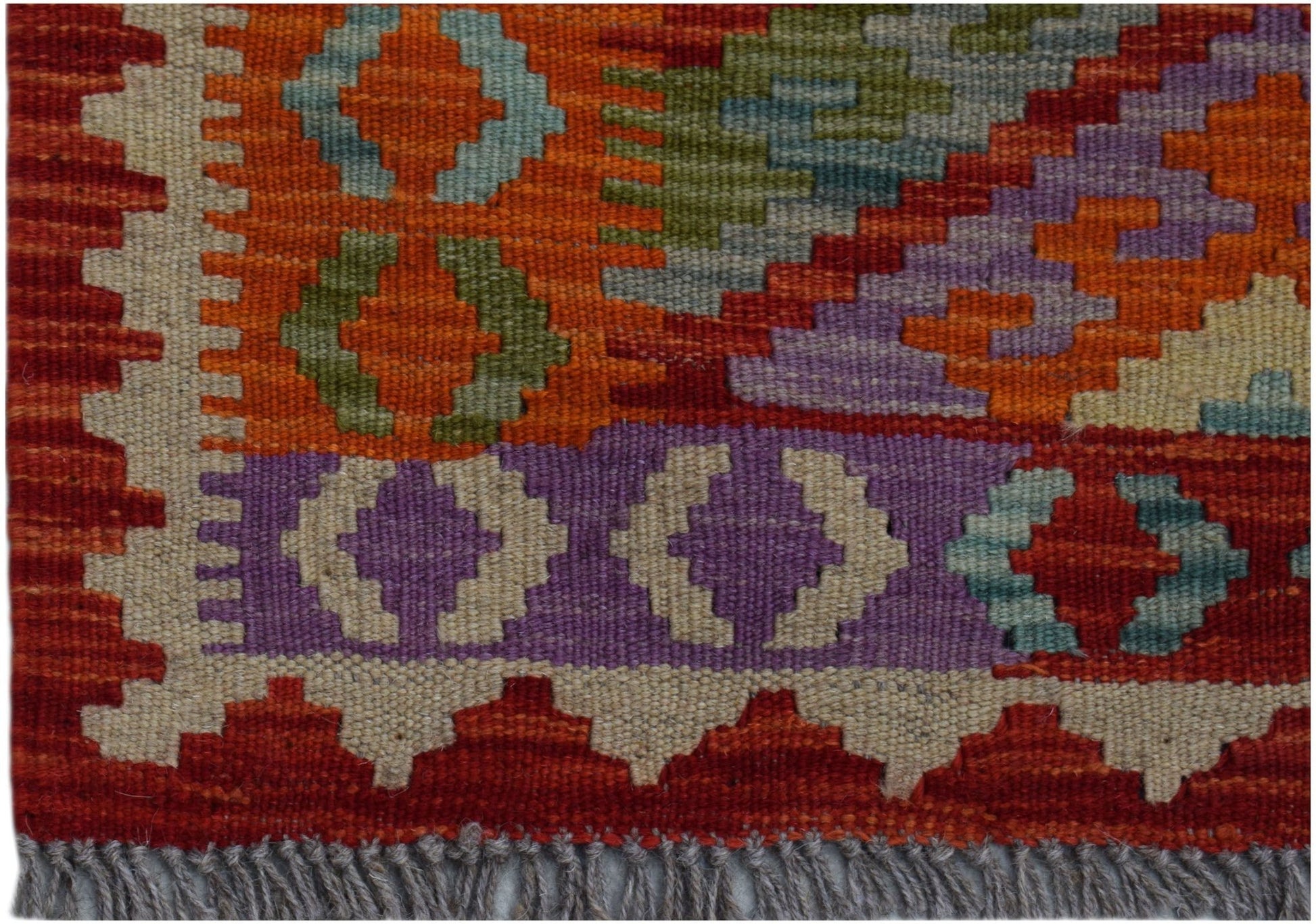 Handwoven Afghan Maimana kilim runner featuring geometric patterns in vibrant wool colors.