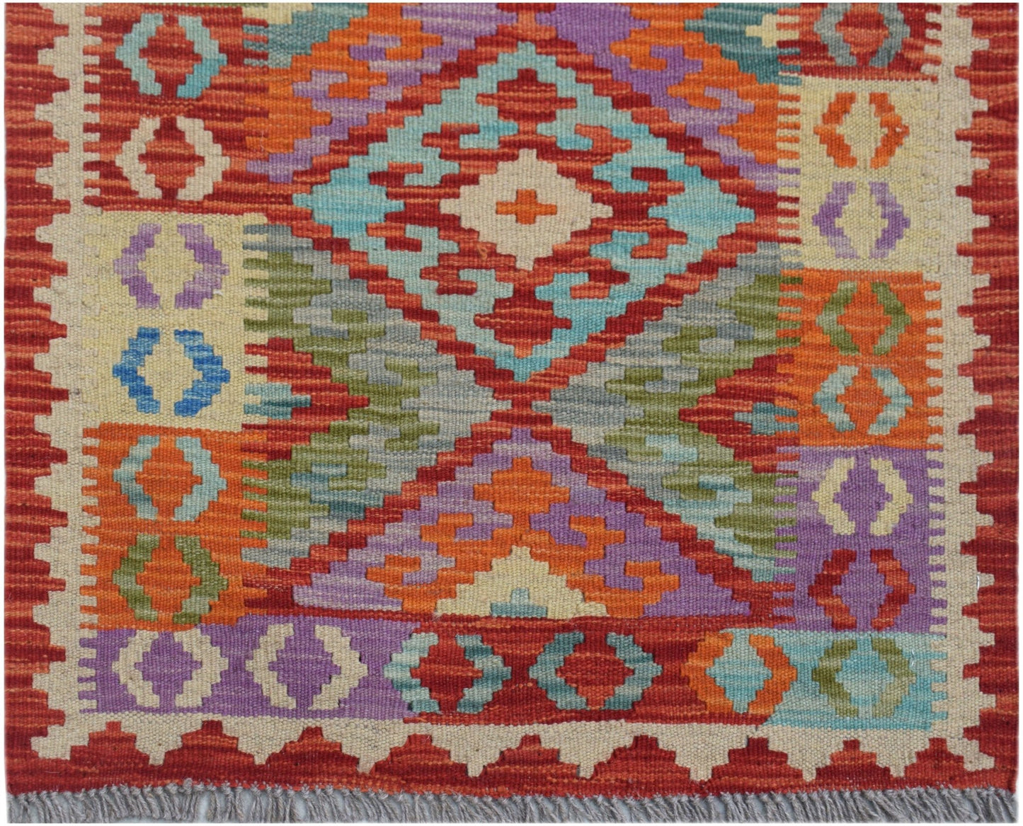 Handwoven Afghan Maimana wool kilim runner featuring a vibrant geometric pattern.