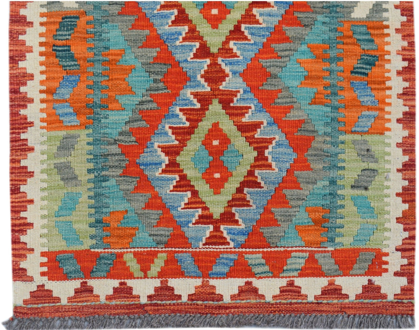 Handwoven Afghan Maimana kilim runner featuring a vibrant geometric pattern in wool.