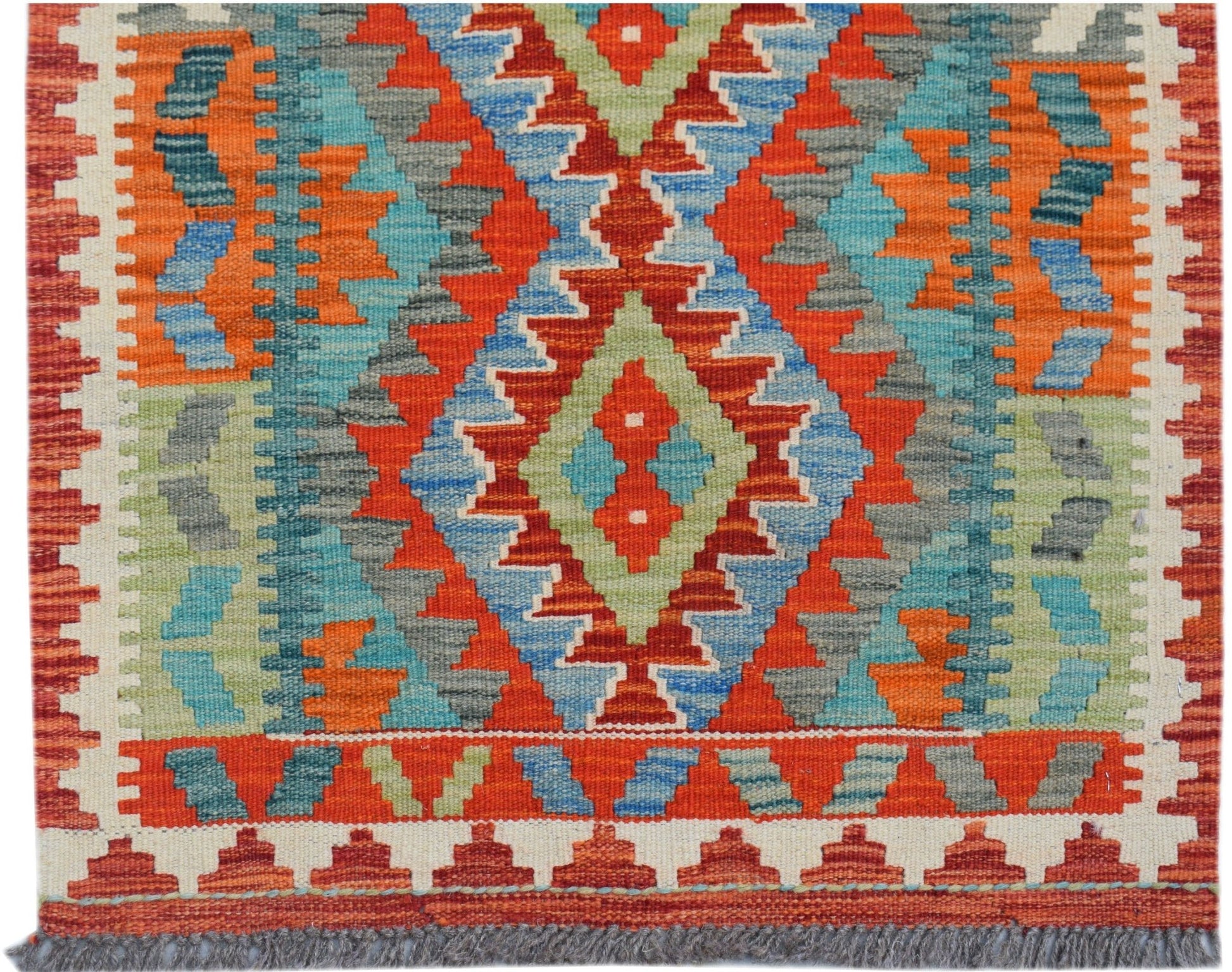 Handwoven Afghan Maimana kilim runner featuring a vibrant geometric pattern in wool.