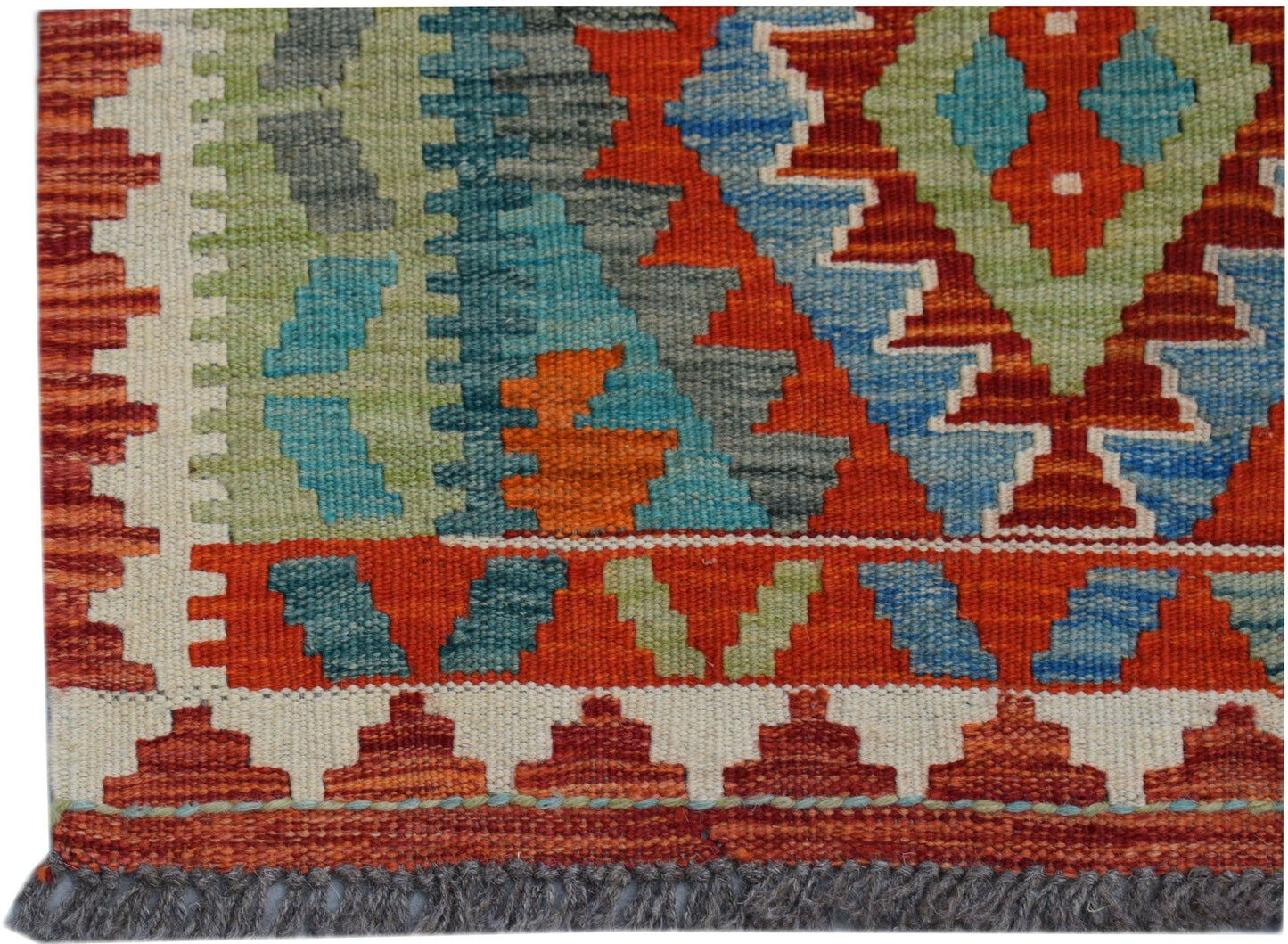 Handwoven Afghan Maimana kilim runner featuring a geometric pattern in red, blue, and green wool.
