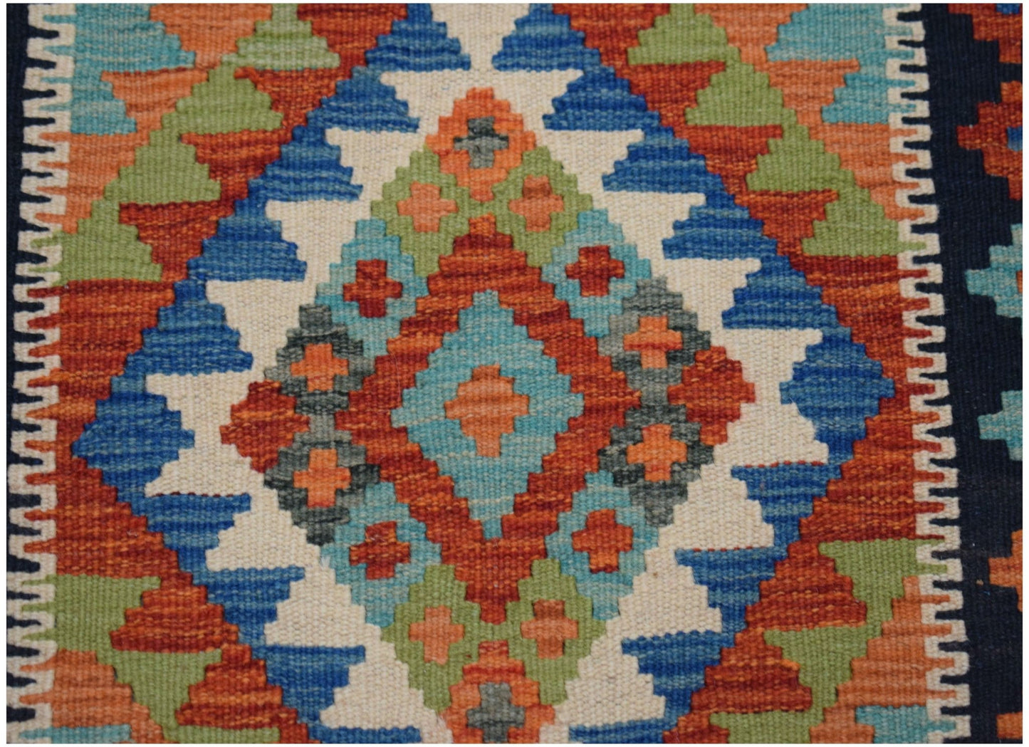 Handwoven Afghan Maimana wool runner featuring a vibrant geometric diamond pattern.