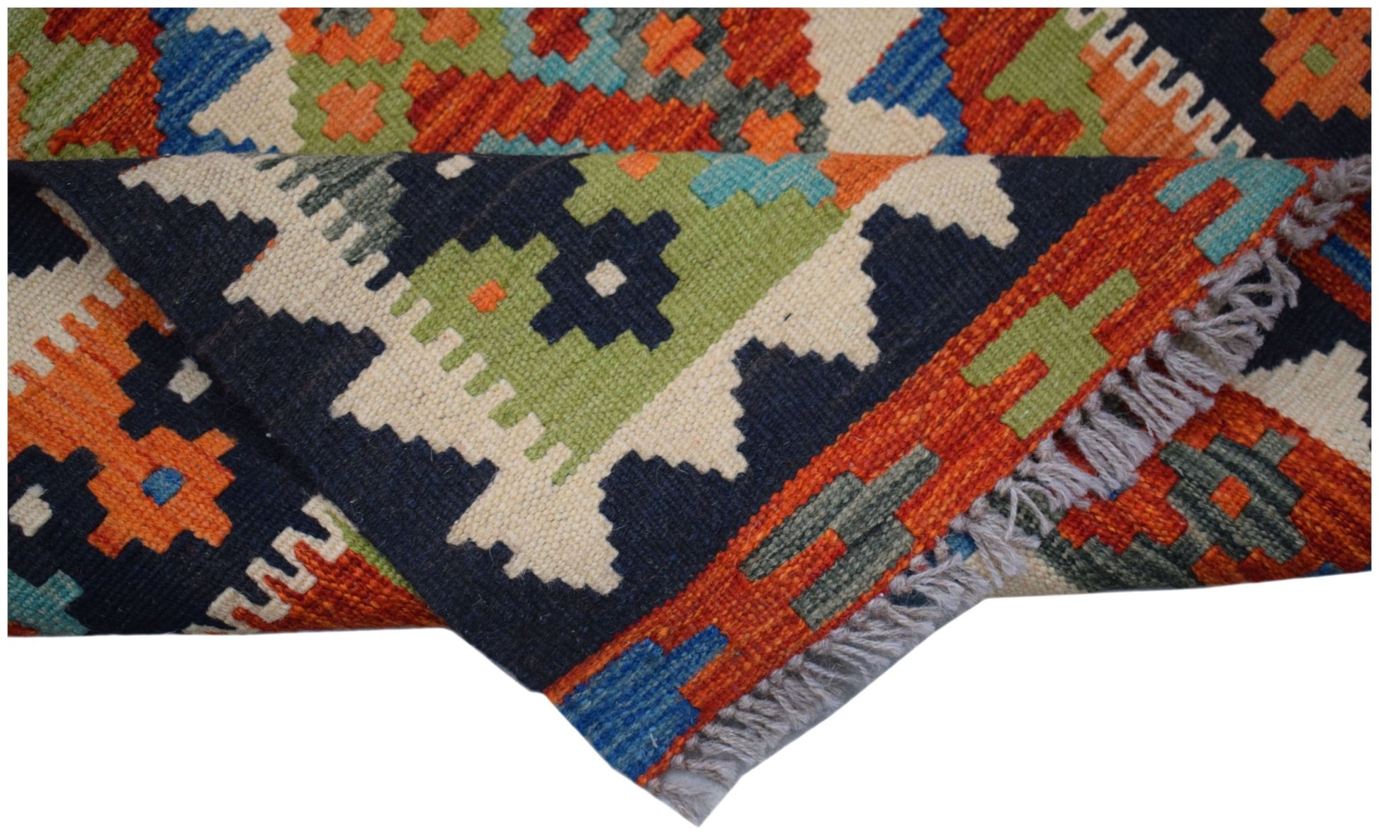 A handwoven Afghan Maimana wool runner featuring a colorful geometric pattern and fringe edges.