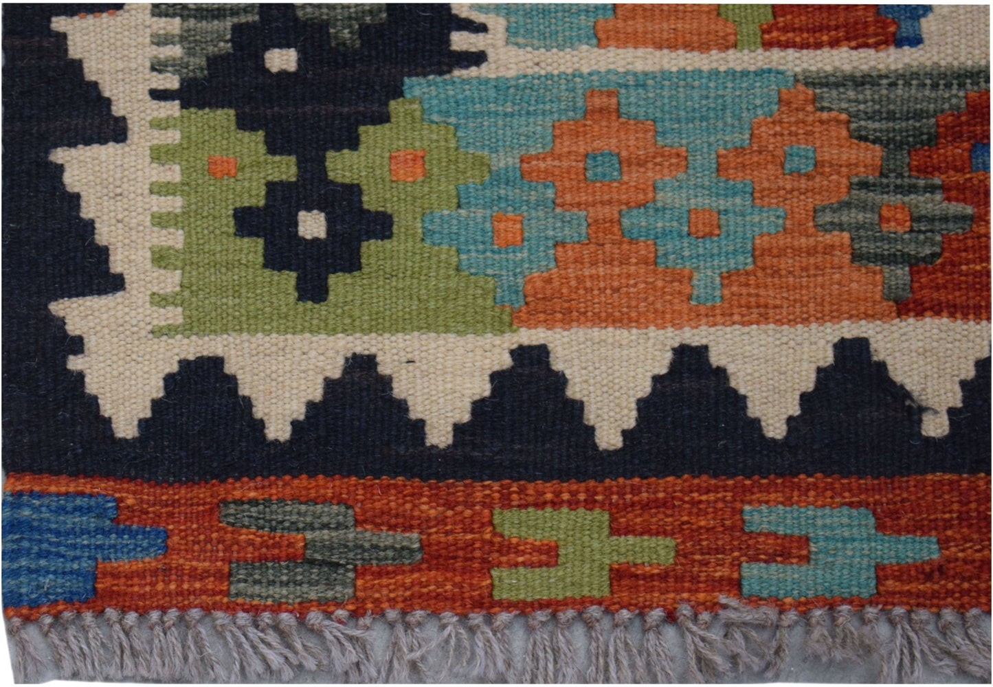 Handwoven Afghan Maimana kilim runner featuring geometric patterns in vibrant wool colors.