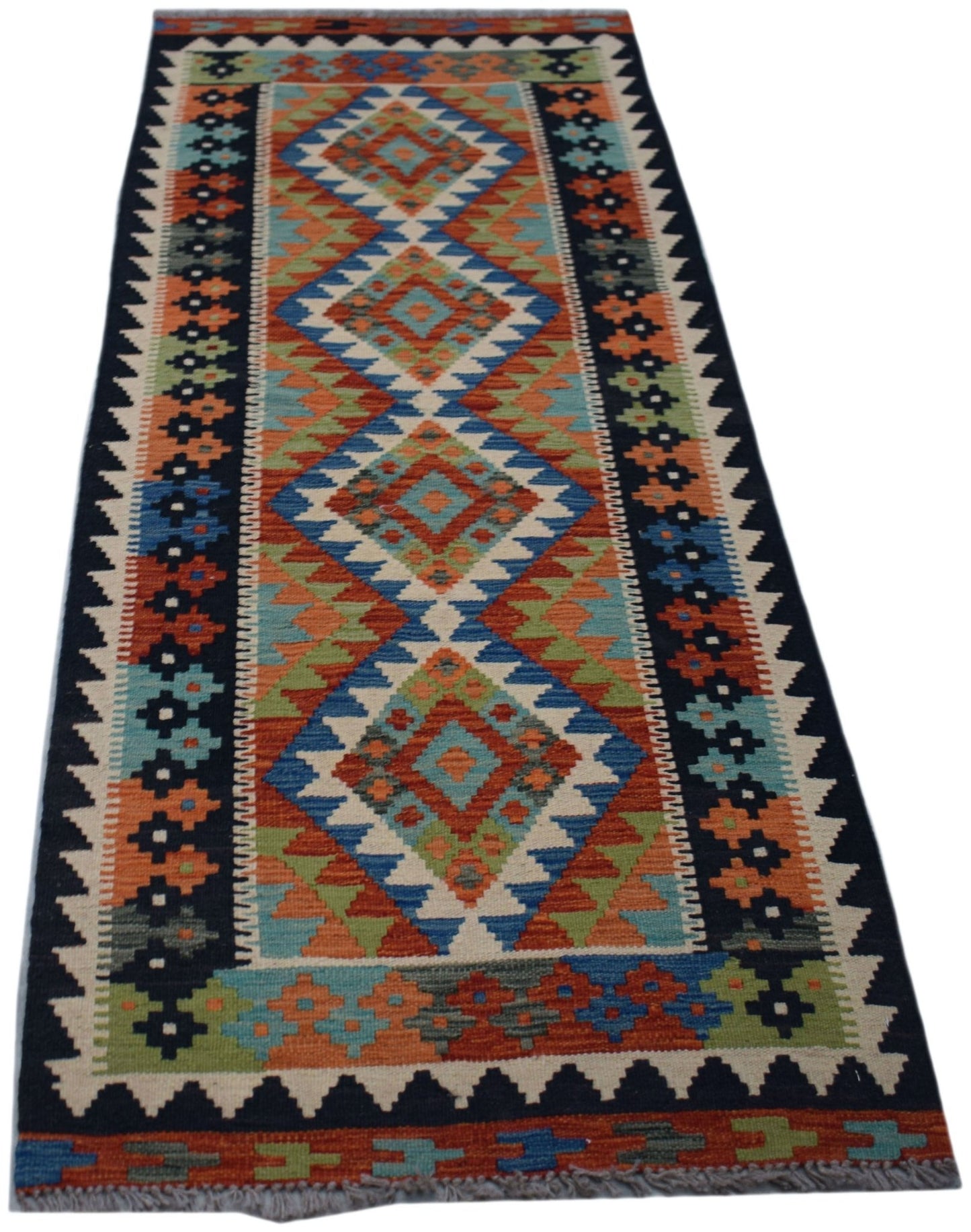 A handmade Afghan Maimana wool runner rug featuring a colorful geometric diamond pattern.