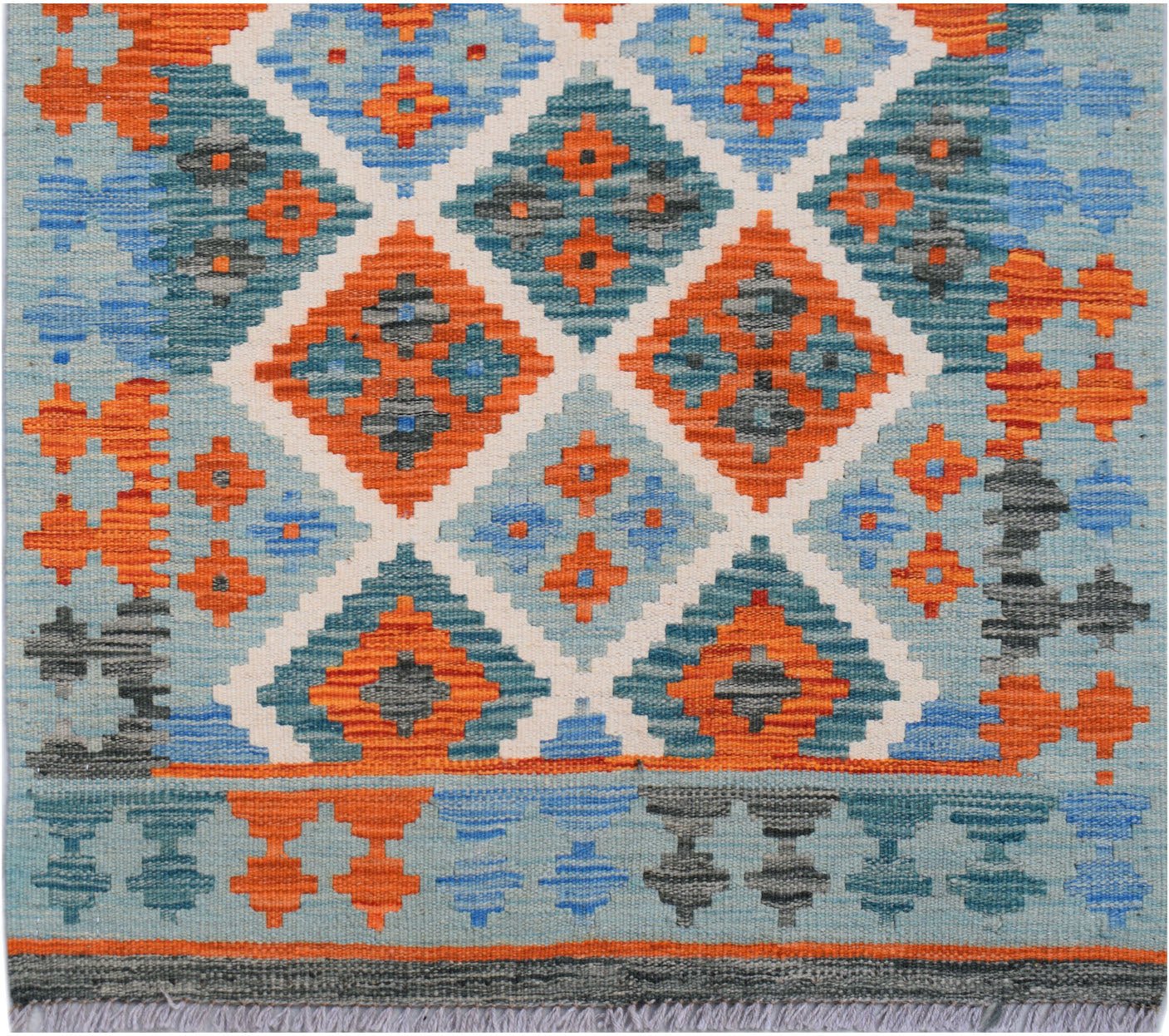 Handwoven Afghan Maimana wool runner featuring a geometric diamond pattern in orange and blue.