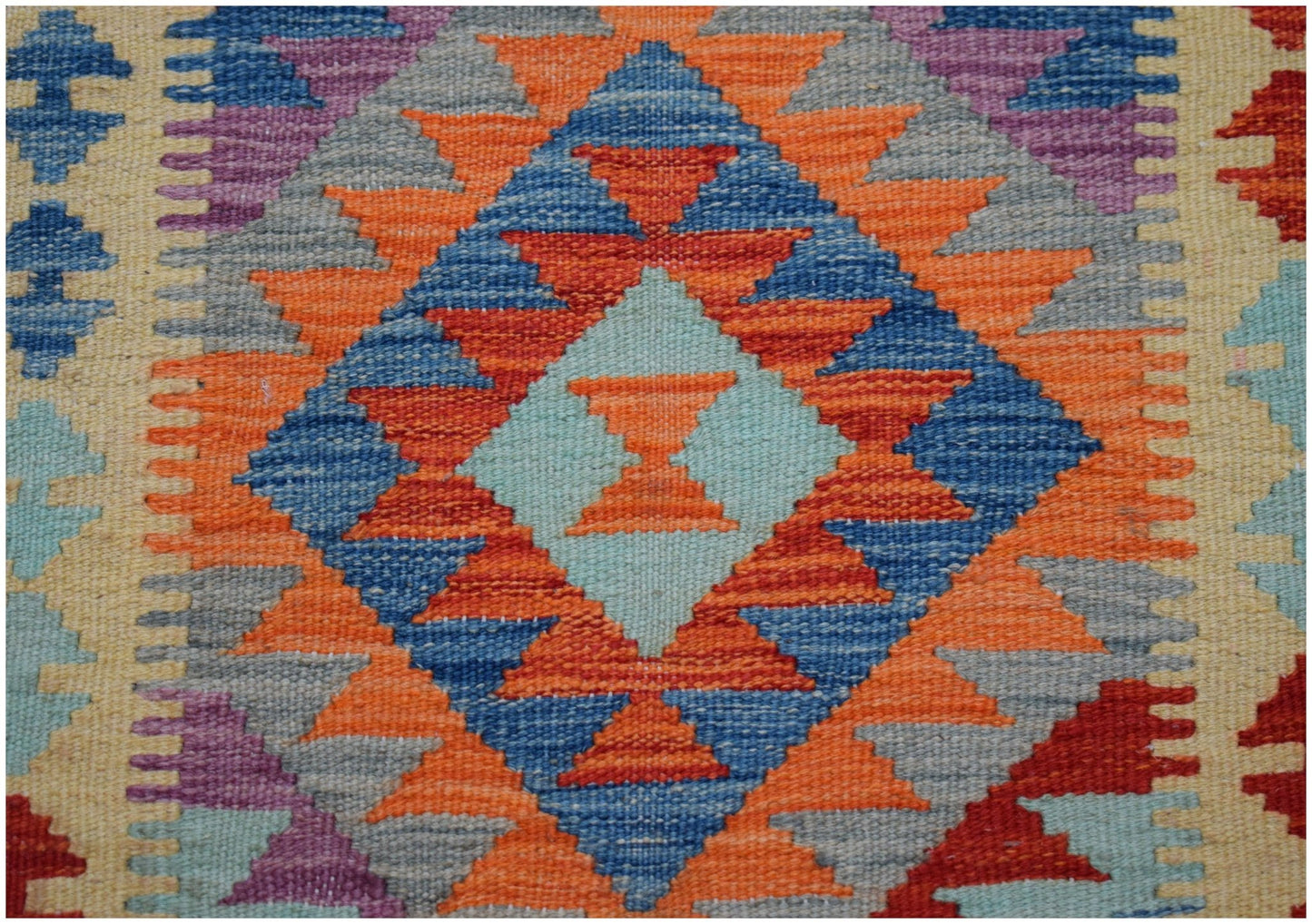 Handwoven Afghan Maimana wool runner featuring a vibrant geometric diamond pattern.
