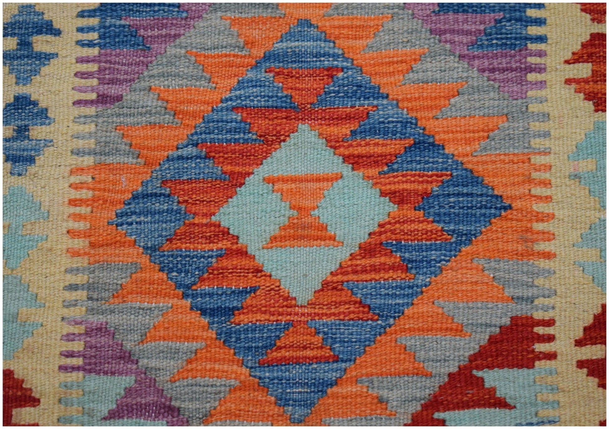 Handwoven Afghan Maimana wool runner featuring a vibrant geometric diamond pattern.