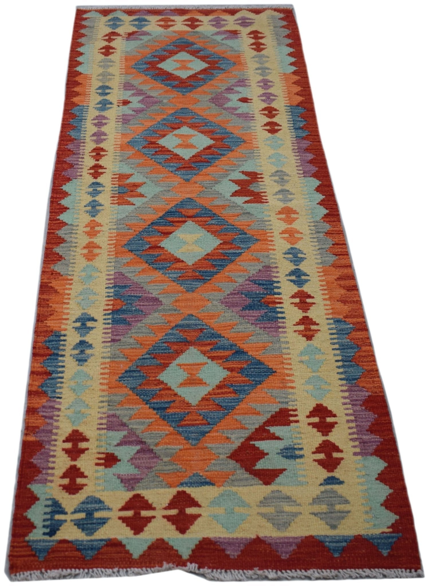 Handwoven Afghan Maimana wool runner rug featuring a colorful geometric diamond pattern.
