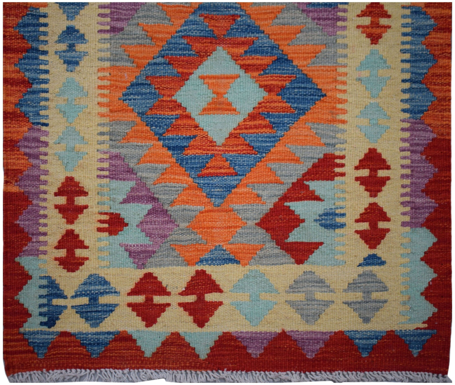 Handwoven Afghan Maimana wool runner featuring a vibrant geometric pattern in a flatweave style.