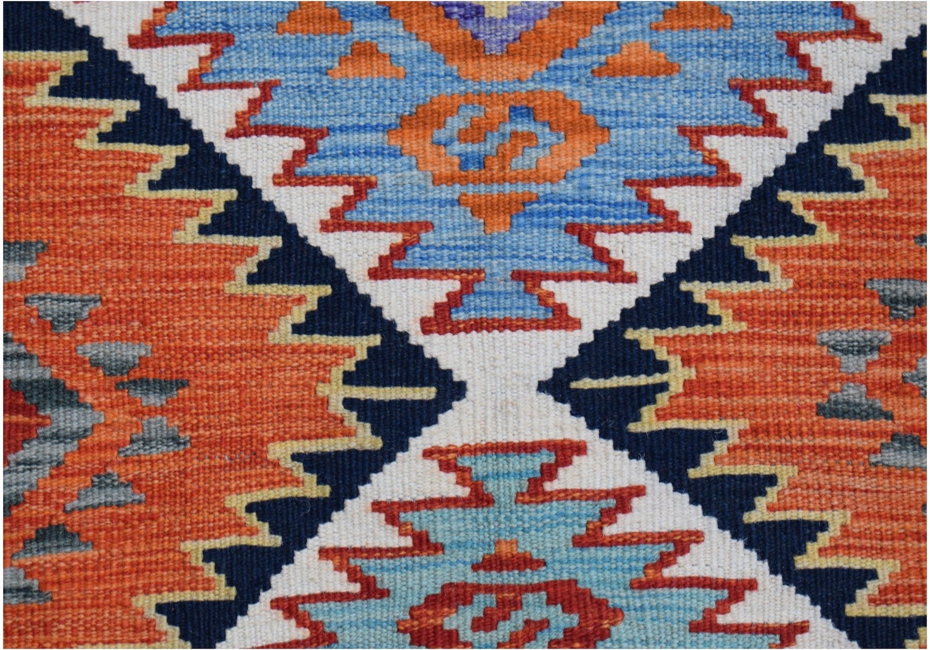 Handwoven Afghan Maimana kilim runner featuring a geometric pattern in orange, blue, and white.