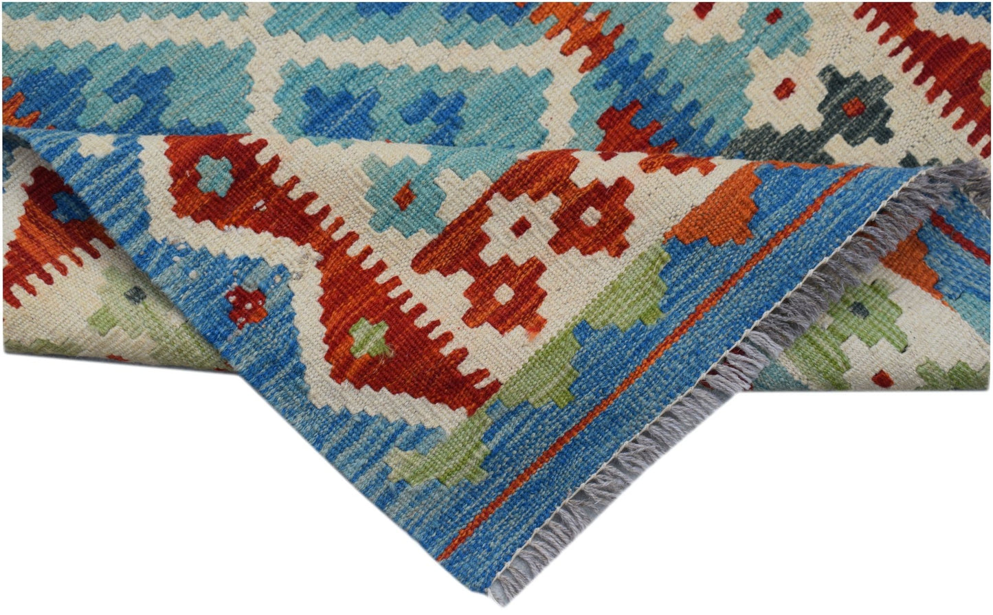 A handmade Afghan Maimana kilim runner featuring a geometric pattern in blue, red, and green wool.