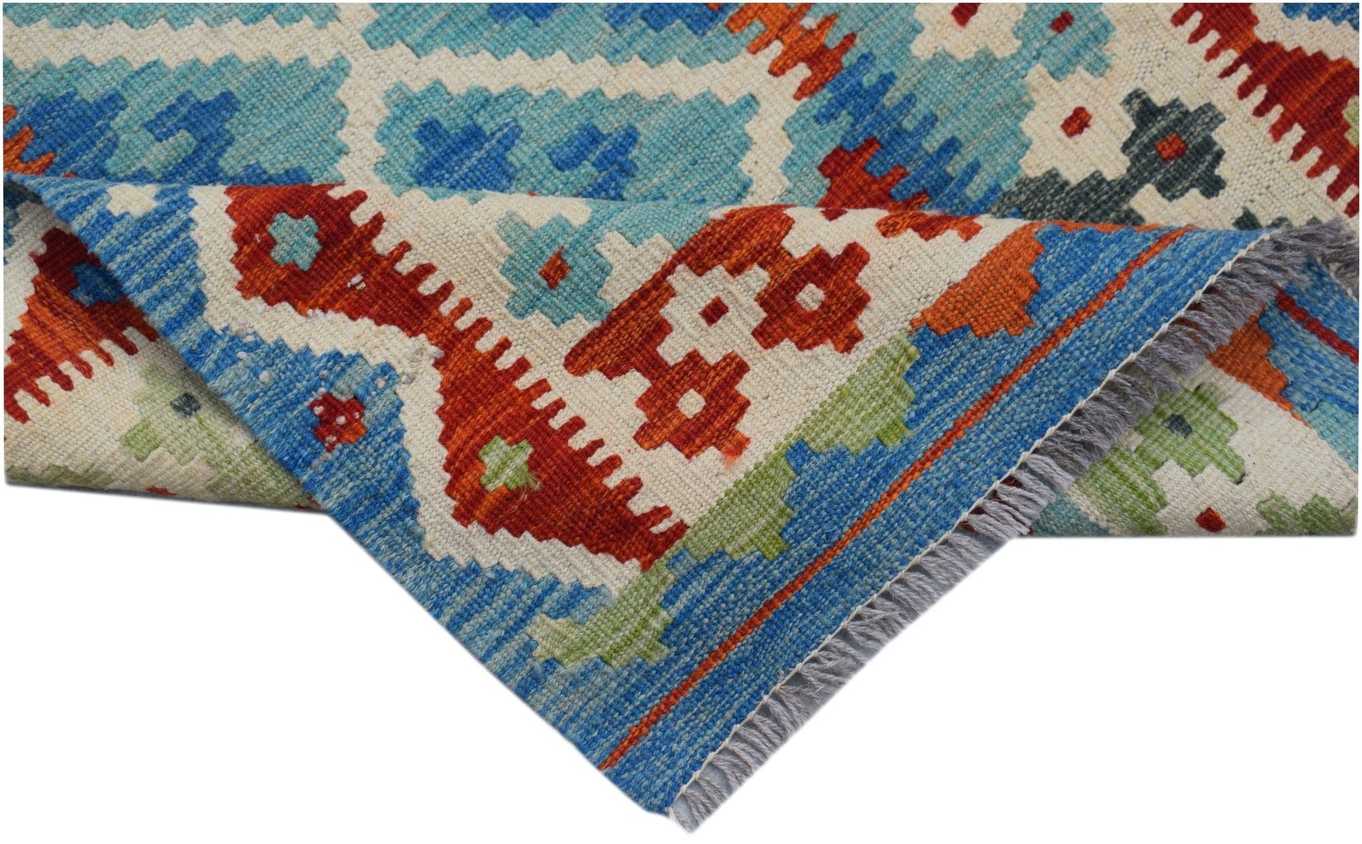 A handmade Afghan Maimana kilim runner featuring a geometric pattern in blue, red, and green wool.
