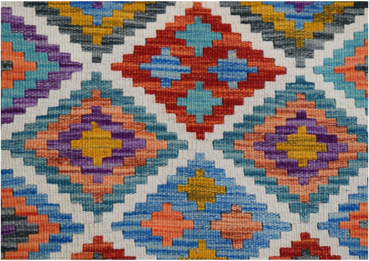 Handwoven Afghan Maimana kilim runner featuring a vibrant geometric diamond pattern in wool.