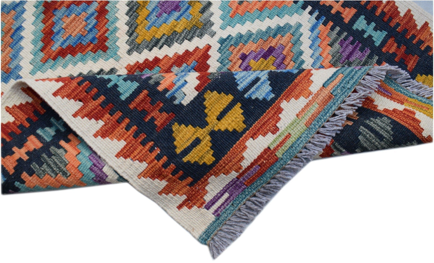 Handwoven Afghan Maimana kilim runner featuring a colorful geometric pattern and fringed edges.