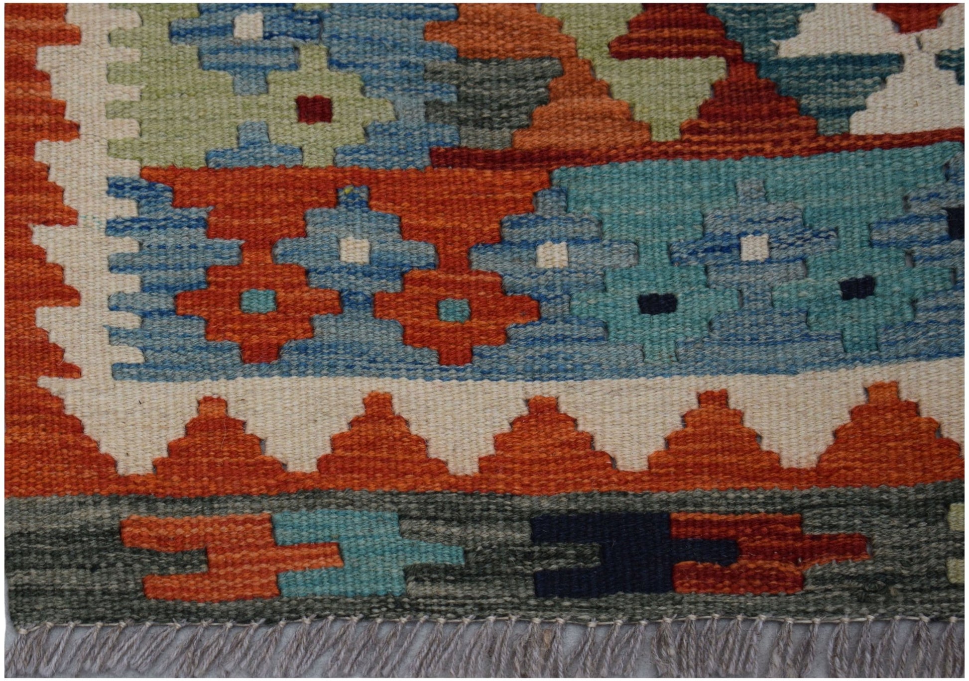 Handwoven Afghan Maimana kilim runner featuring a geometric pattern in vibrant wool colors.