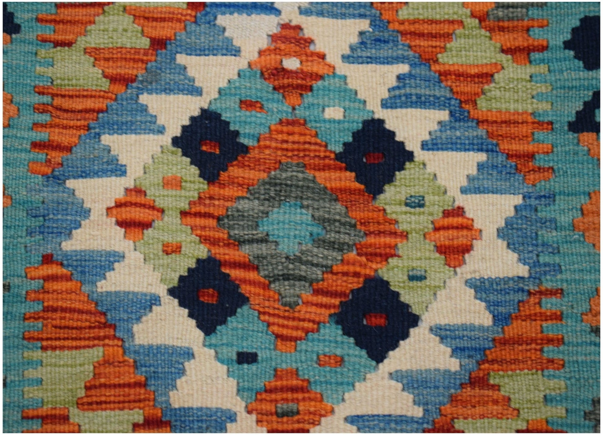 Handwoven Afghan Maimana kilim runner featuring a vibrant geometric diamond pattern in wool.
