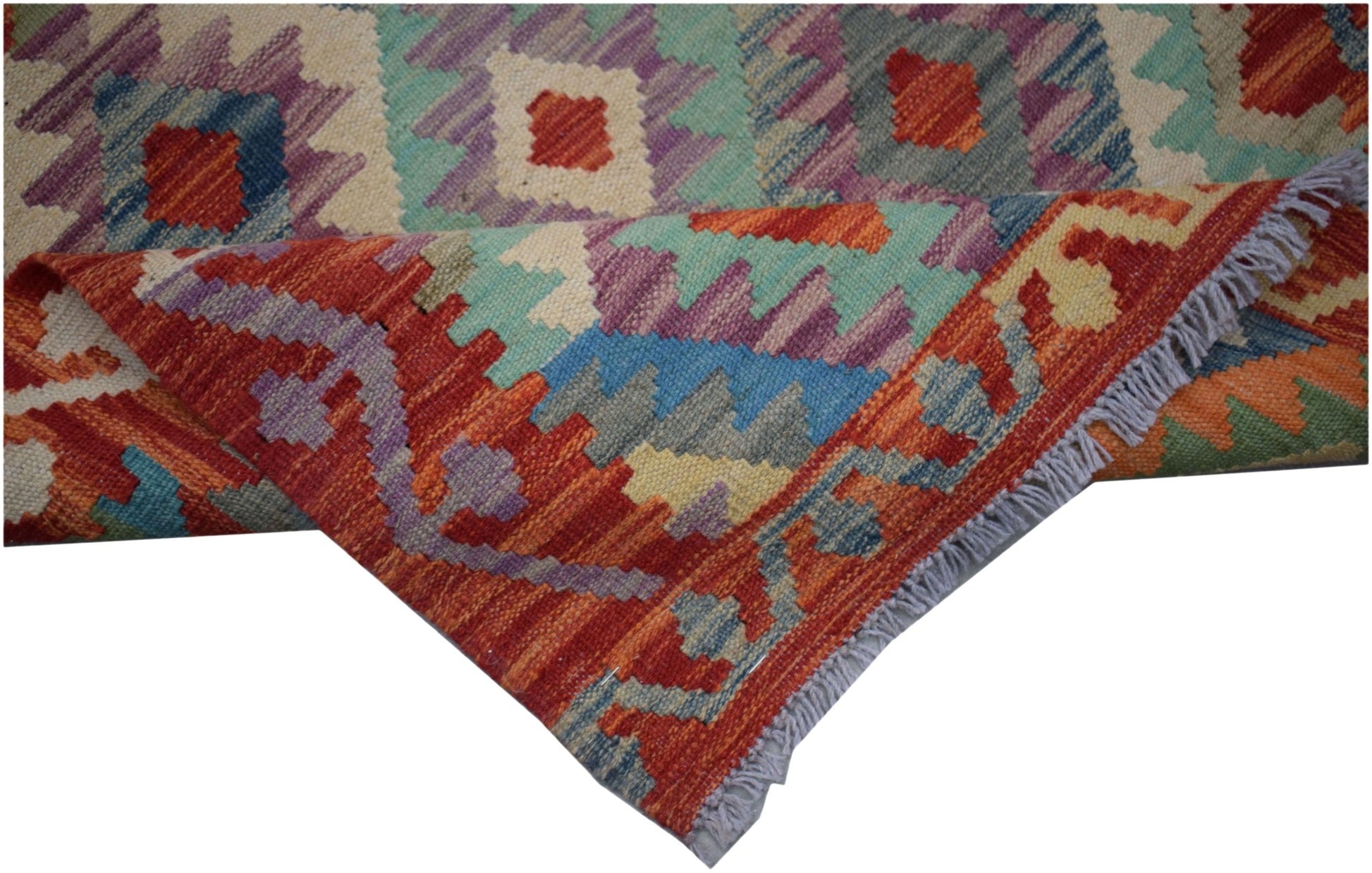 Handwoven Afghan Maimana kilim runner featuring colorful geometric patterns and a flatweave texture.