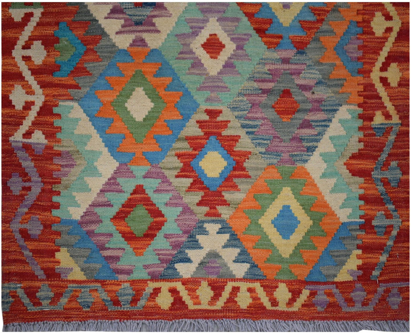 Handwoven Afghan Maimana wool runner featuring a vibrant geometric diamond pattern.