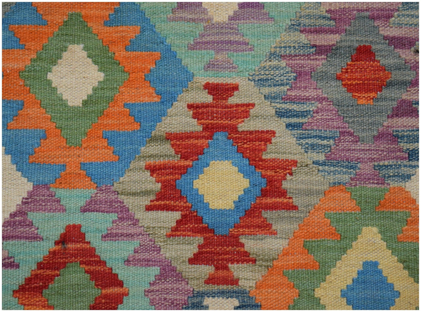 Handwoven Afghan Maimana kilim runner featuring a vibrant geometric diamond pattern in wool.
