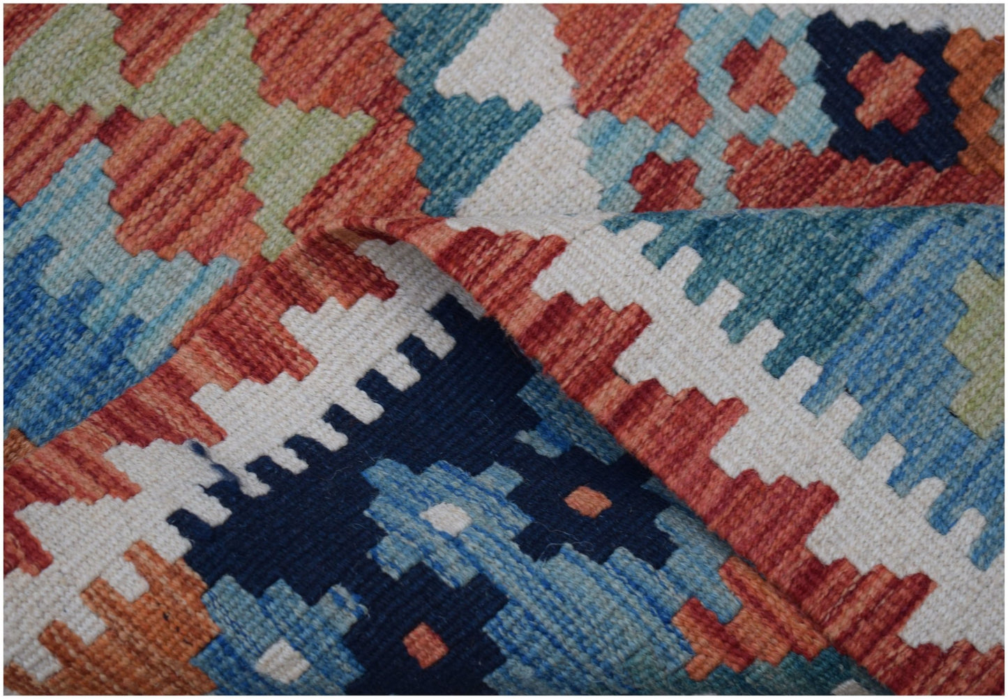 A handmade Afghan Maimana wool kilim runner featuring a colorful geometric pattern.