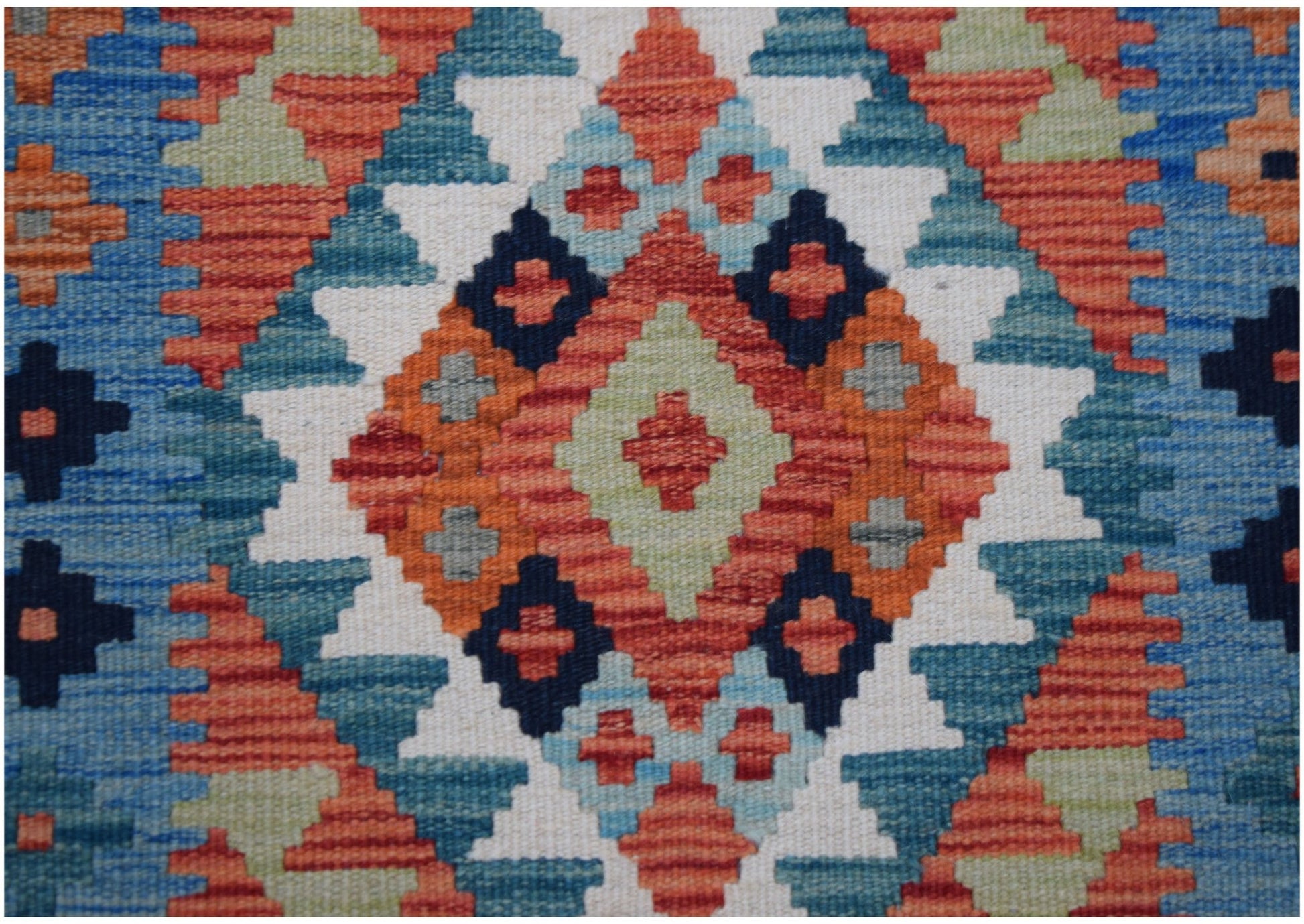 Handwoven Afghan Maimana wool runner featuring a geometric diamond pattern in vibrant colors.