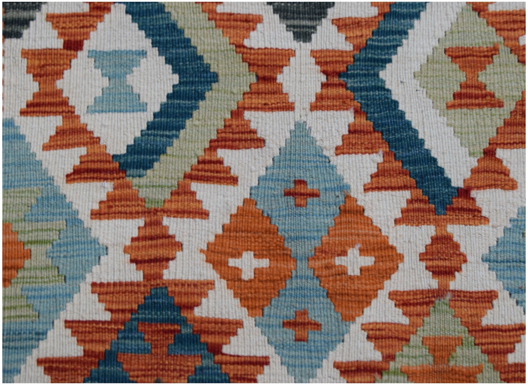 Handwoven Afghan Maimana wool kilim runner featuring a geometric diamond pattern in vibrant colors.