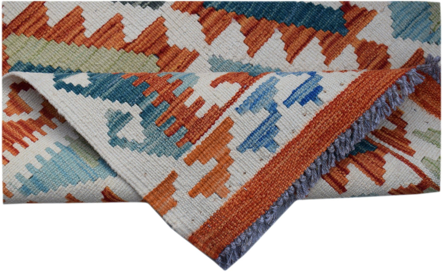 A handwoven Afghan Maimana kilim runner featuring geometric patterns in orange, blue, and cream.