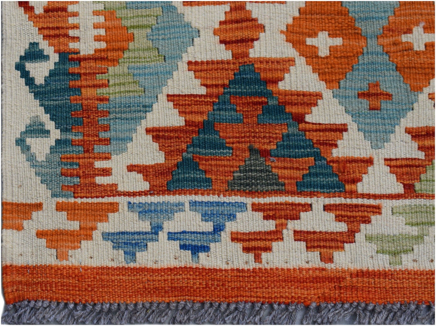 Handwoven Afghan Maimana kilim runner featuring geometric patterns in orange, blue, and green.