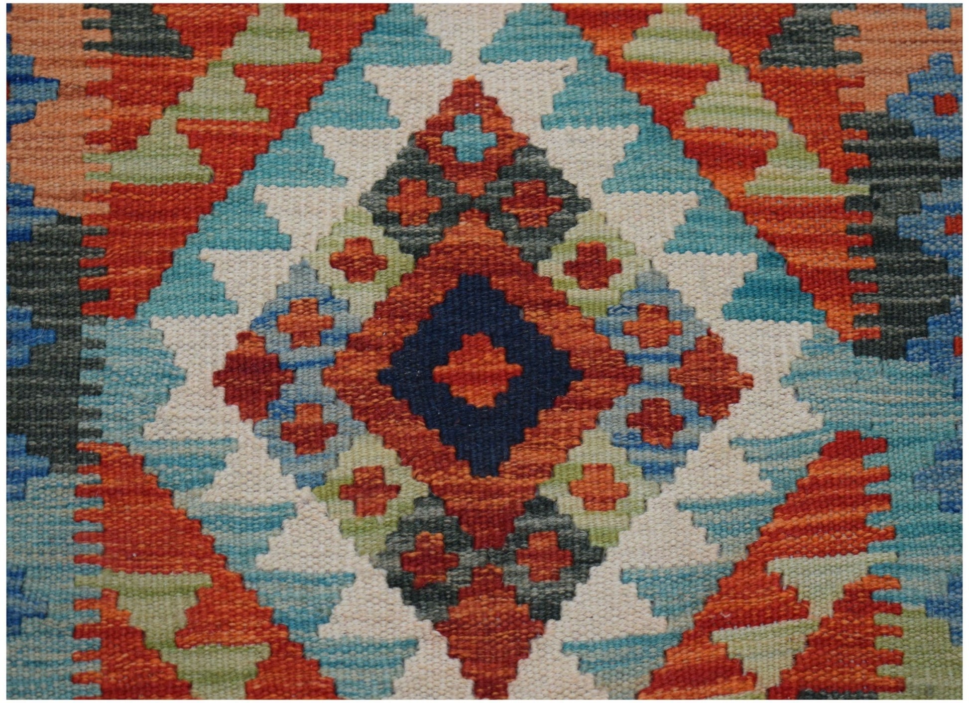 Handwoven Afghan Maimana wool runner featuring a vibrant geometric diamond pattern.