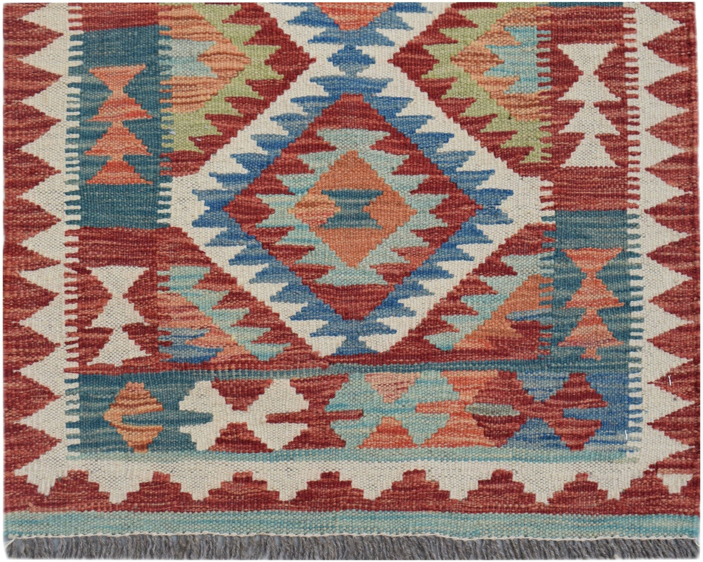 Handwoven Afghan Maimana wool runner featuring a geometric diamond pattern in red, blue, and tan.