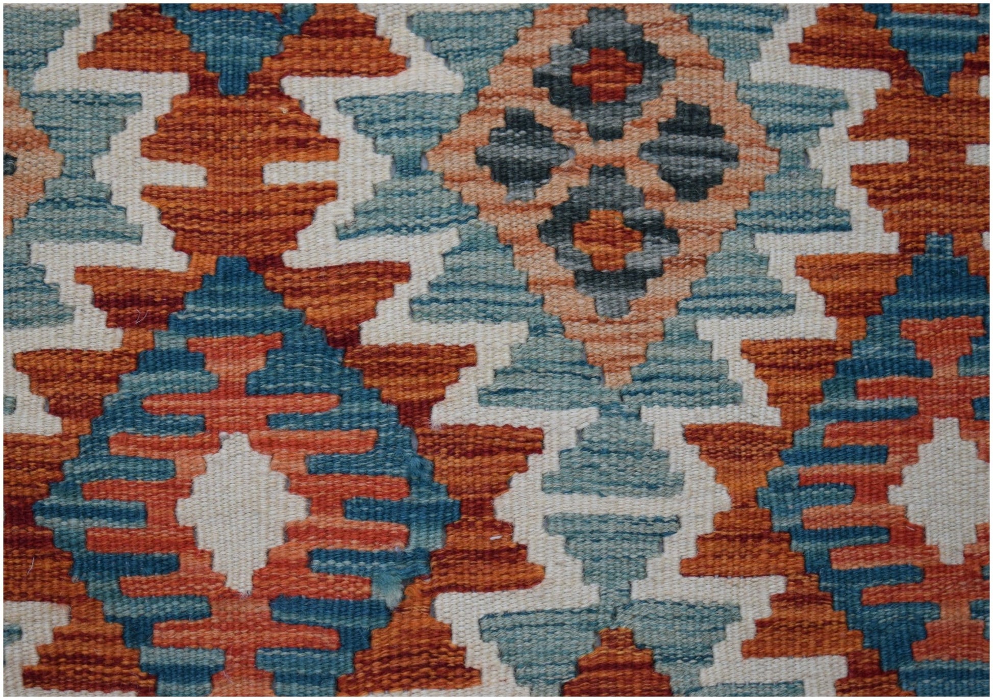 Handwoven Afghan Maimana kilim runner featuring a geometric pattern in orange, blue, and cream.