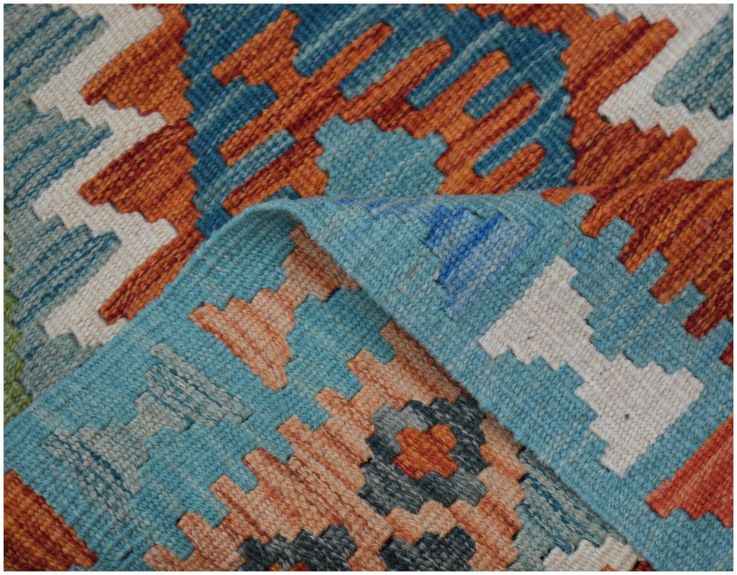 A handwoven Afghan Maimana kilim runner featuring a geometric pattern in orange, blue, and white.