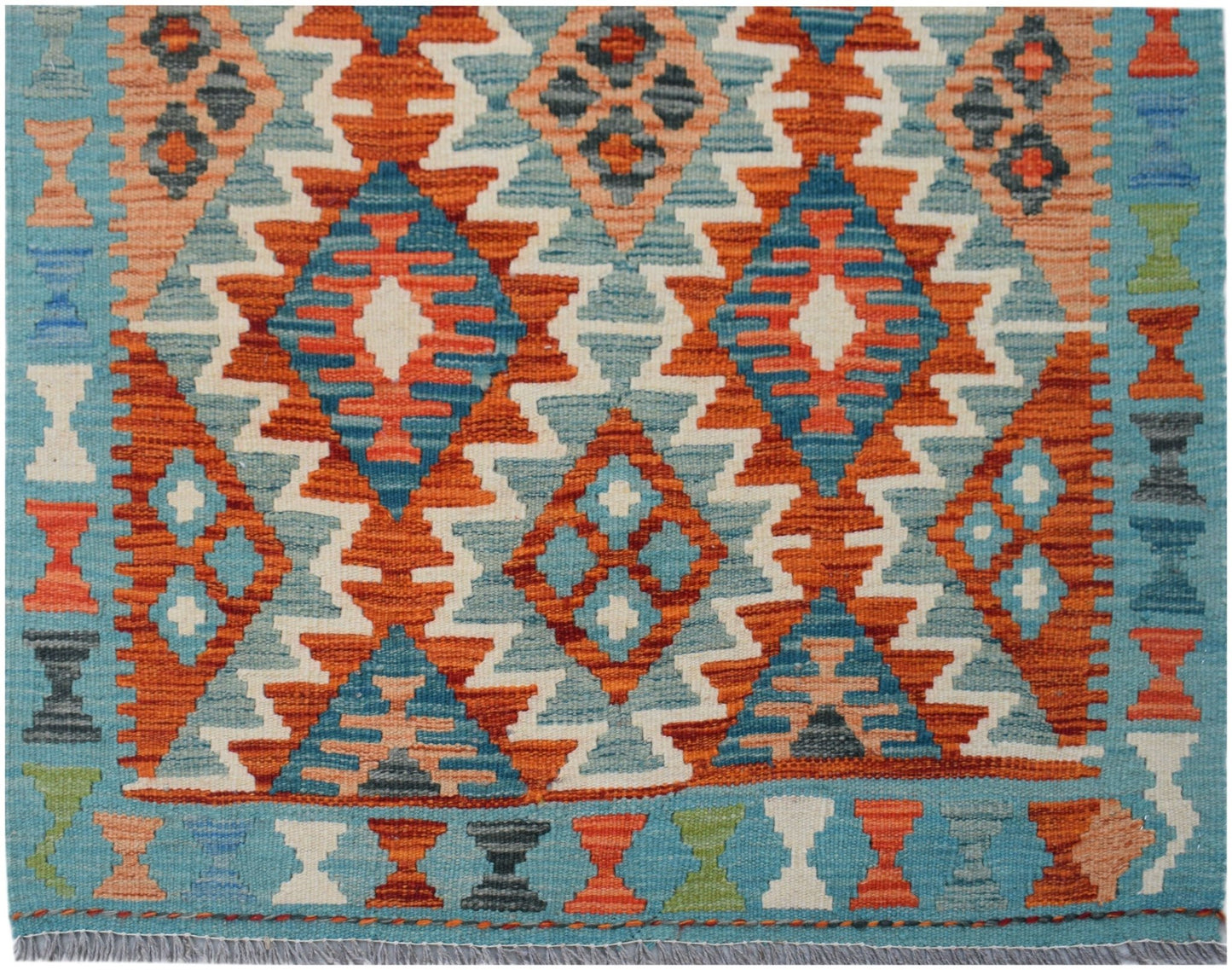 Handwoven Afghan Maimana kilim runner featuring a geometric diamond pattern in vibrant colors.