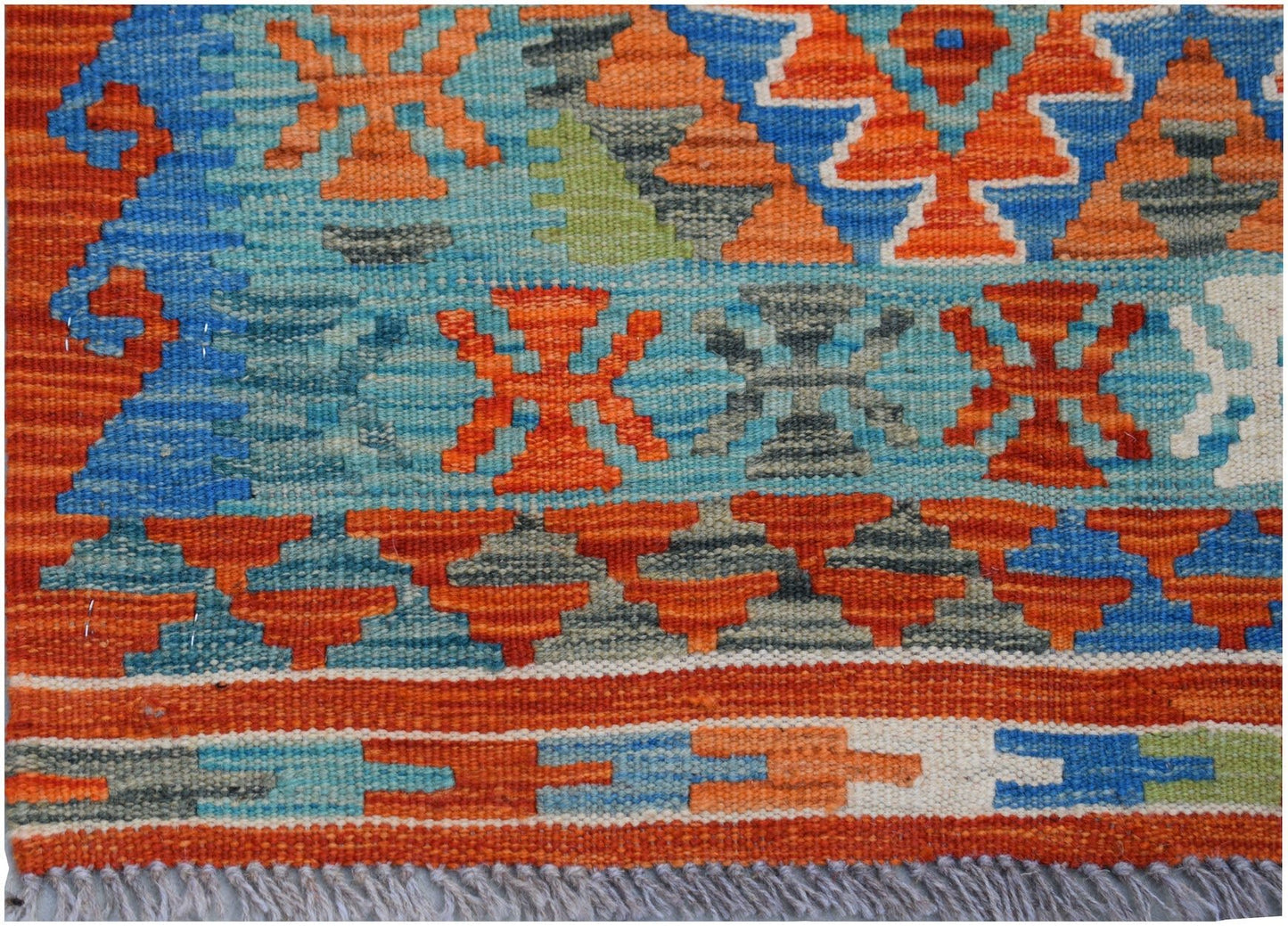 Handwoven Afghan Maimana wool runner featuring a geometric pattern in orange, blue, and grey.