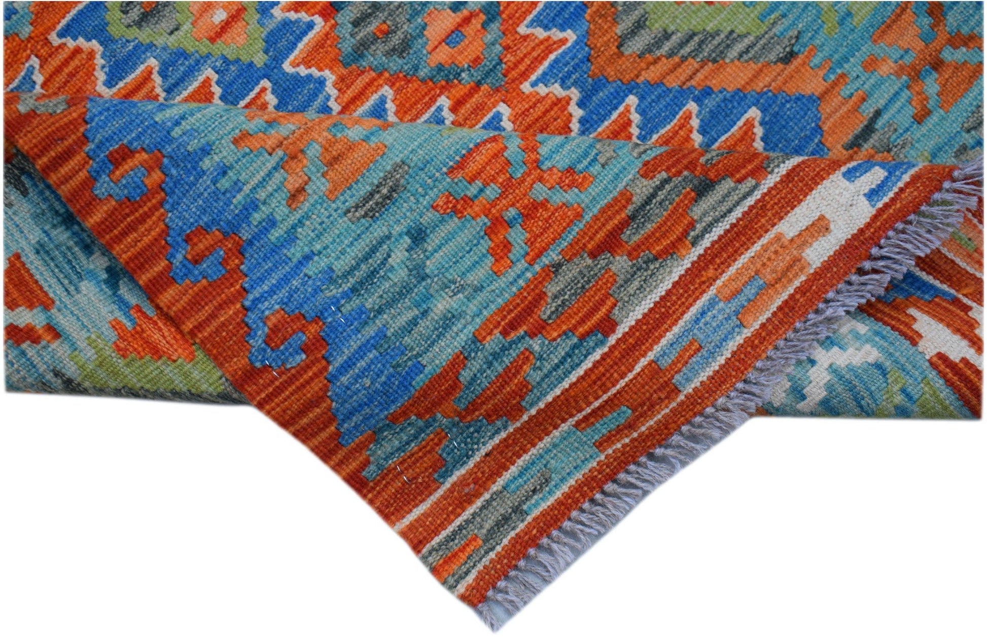 A handwoven Afghan Maimana kilim runner featuring geometric patterns in blue, orange, and green.
