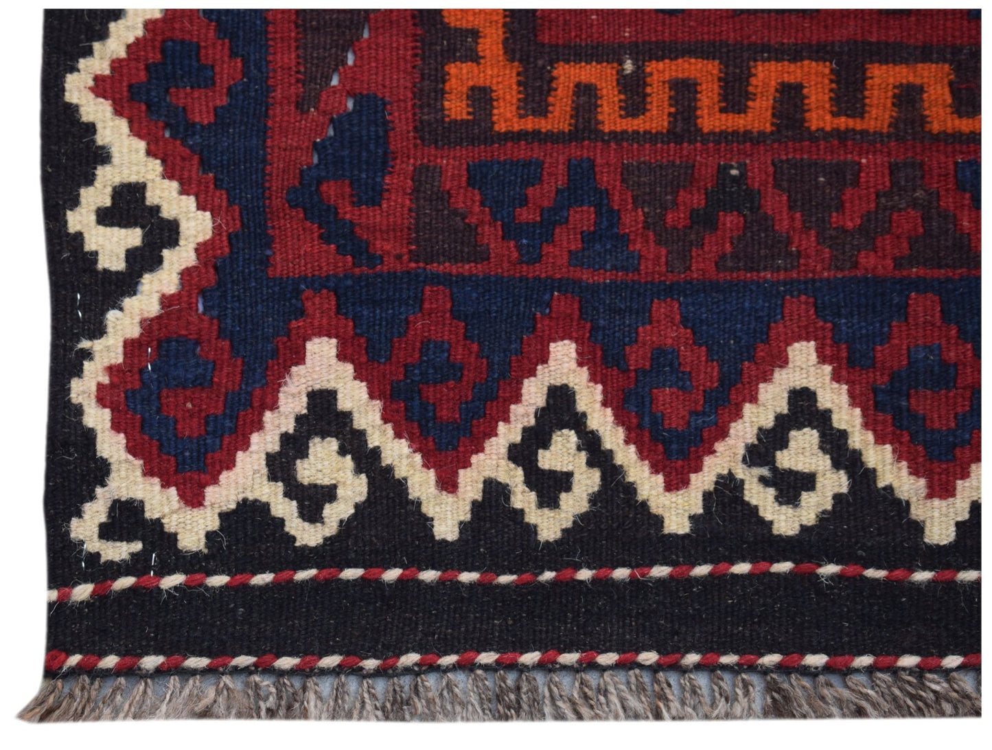 Handwoven Afghan Maimana kilim runner featuring geometric patterns in red, blue, and cream wool.