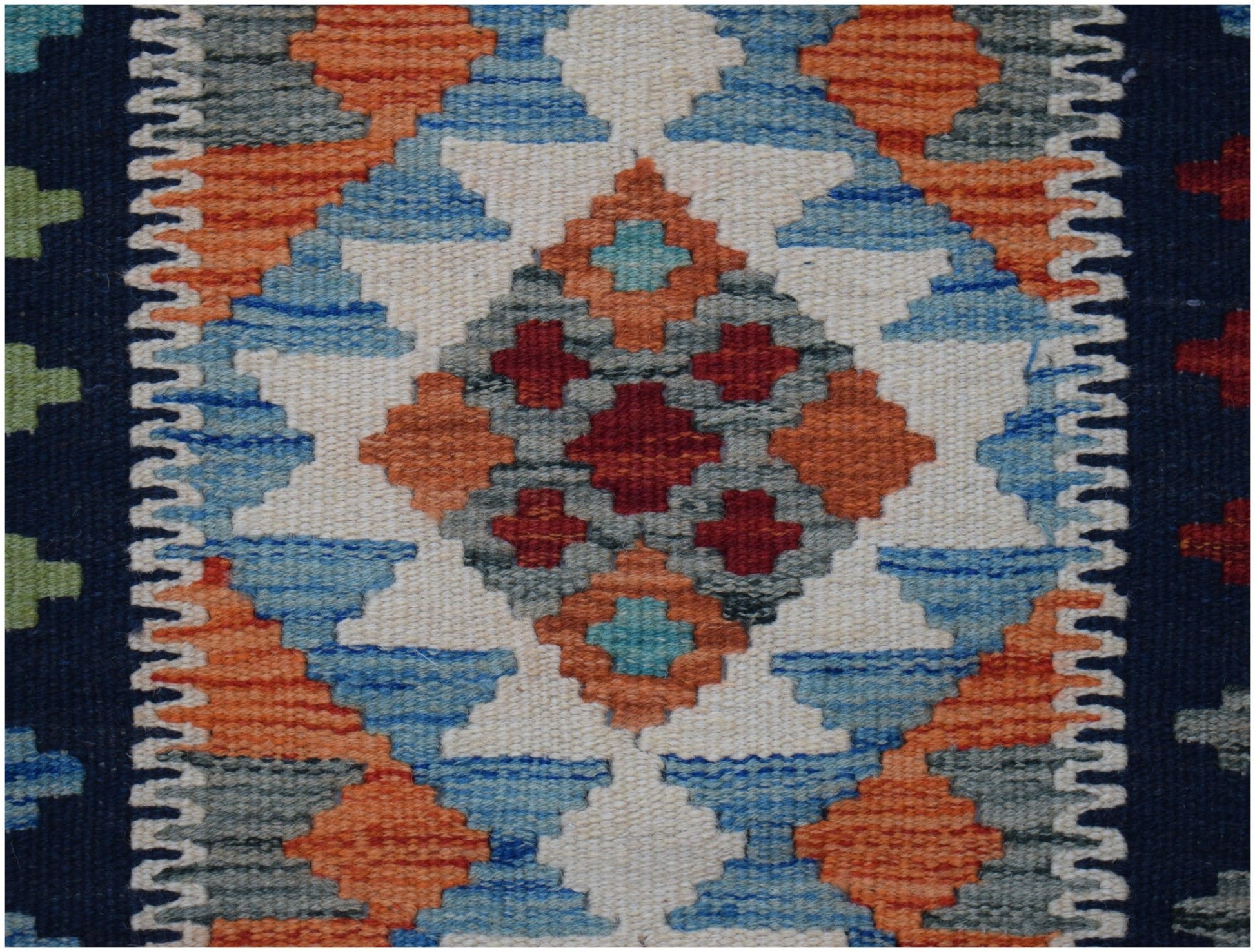 Handwoven Afghan Maimana kilim runner featuring a geometric diamond pattern in vibrant colors.