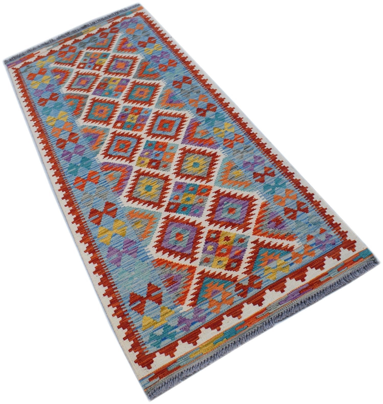 A handmade Afghan Maimana wool runner rug featuring a colorful geometric diamond pattern.