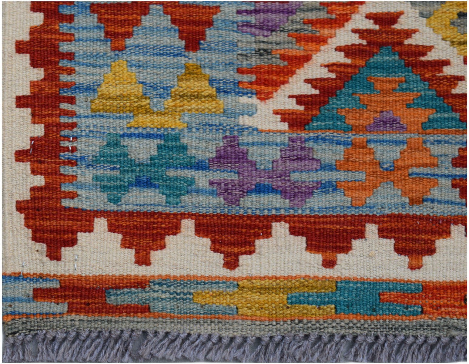 Handwoven Afghan Maimana wool kilim runner featuring a vibrant geometric pattern and fringe ends.